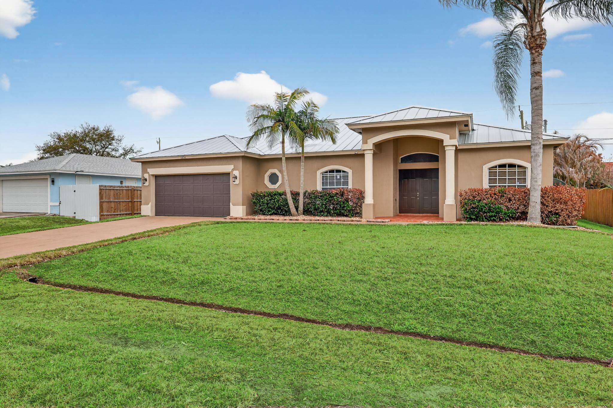 GREAT LOCATION -- A MUST SEE!
Beautifully landscaped and meticulously maintained, this CBS home with a metal roof (2024) offers comfort, style, and durability. Located in a quiet neighborhood with quick access to both I-95 and the Turnpike, this property is perfect for commuters.
This spacious 4-bedroom, 2-bath, 2-car garage home has been freshly painted inside and features a bright, open floor plan ideal for entertaining. The kitchen boasts stainless steel appliances, granite countertops, and an impressive 13' island, a true centerpiece for gatherings.
The primary suite includes:
Jetted soaking tub
Separate walk-in shower
Dual vanities, His & Her walk-in closets.

NEW AC installed (2023)
Fully fenced backyard
Outdoor storage shed
Sprinkler system

MOTIVATED SELLER!