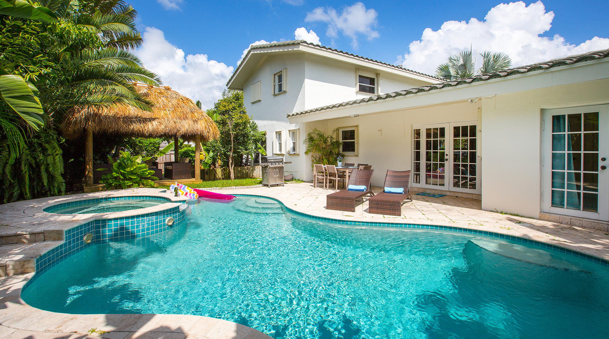 Beautifully updated 4BR/3BA home in the desirable Hillsboro Shores neighborhood of Pompano Beach. Situated on an oversized corner lot, this property features a bright open floor plan with vaulted ceilings, spacious living areas, and abundant natural light. The modern kitchen offers quality appliances and ample storage, ideal for everyday living and entertaining. Step outside to a private backyard oasis complete with a heated pool and spa, lush landscaping, and multiple patio areas. Optional HOA provides access to a private beach. Conveniently located near shopping, dining, and major roadways. Ideal as a primary residence, vacation home, or investment property.