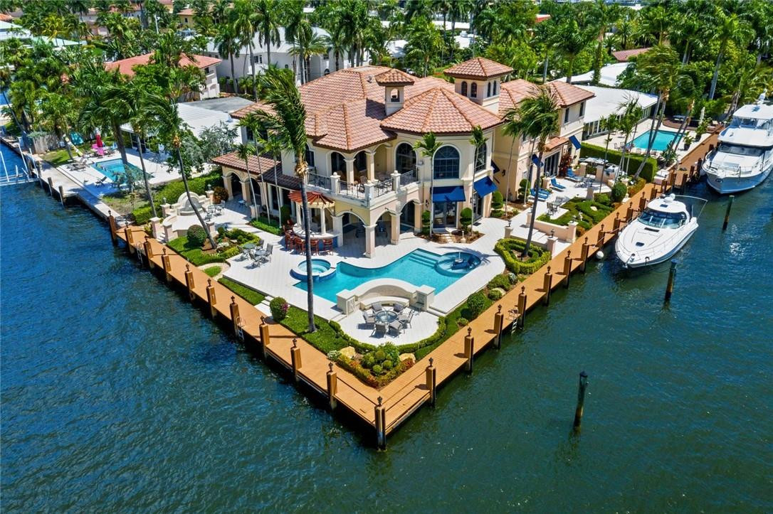 INTRACOASTAL POINT LOT WITH 238 FT OF WATER FRONTAGE AND WIDE WATER VIEWS. STEP INTO THIS BEAUTIFUL HOME WITH 38 FT COFFER CEILINGS WITH SPECTACULAR DETAIL, GOURMET KITCHEN WITH ONLY THE FINEST FINISHES, GAS FIREPLACE PRIVATE GYM, ELEVATOR, SPECTACULAR WATER VIEWS FROM ALMOST EVERY ROOM IN THE HOUSE. IF YOU LIKE TO ENTERTAIN THIS HOME HAS IT ALL, WINE CELLAR, GAME ROOM WITH BAR, OUTSIDE SUMMER KITCHEN AND LOTS OF COVERED PATIO AREA.  3 CAR GARAGE, ELECTRONIC GATE FOR PRIVACY AND SECURITY. LOCATED ON THE BARRIER ISLAND. THIS HOME HAS IT ALL.