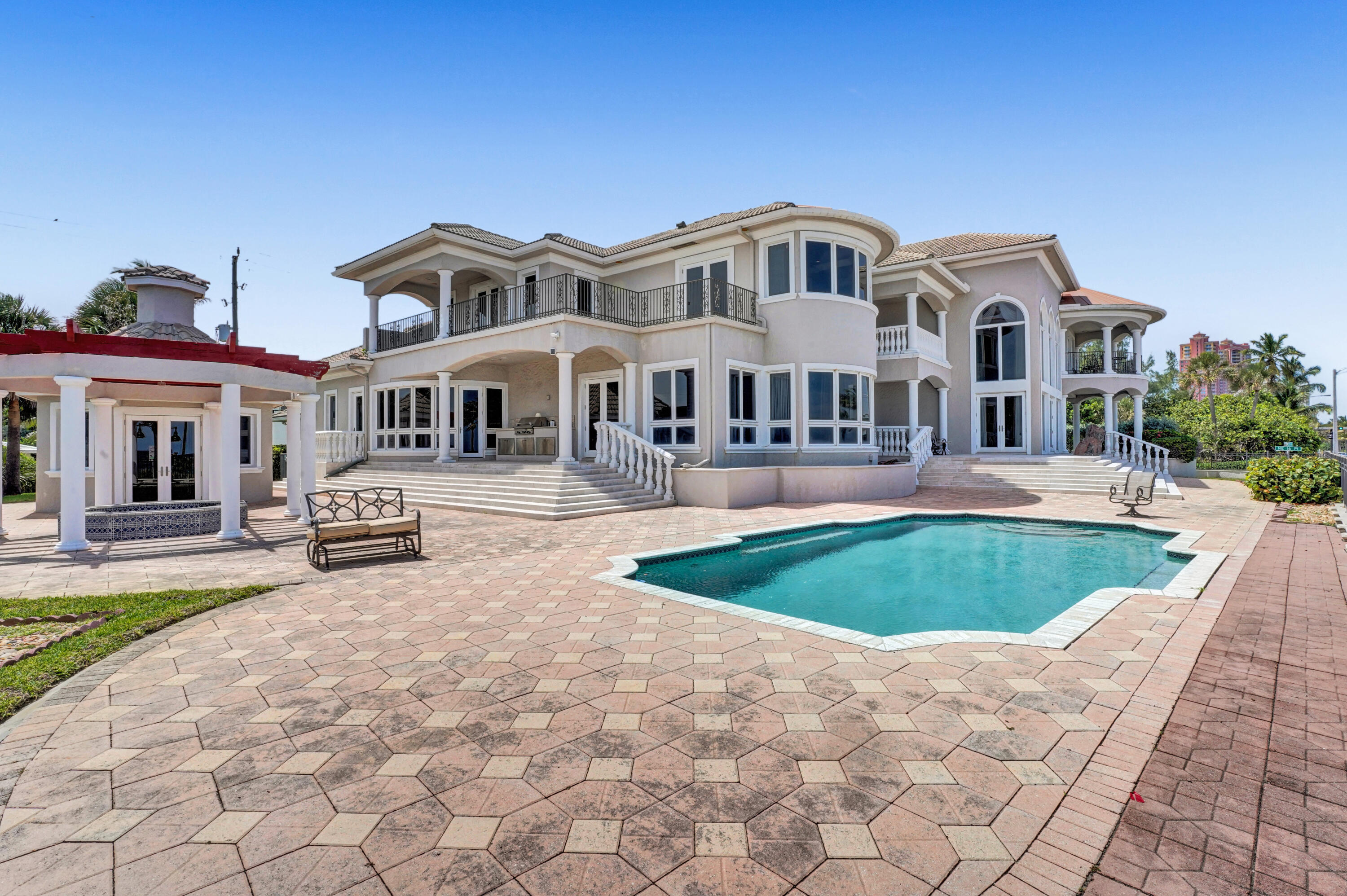 This one-of-a-kind palatial beachfront mansion fronts the crystalline ocean waters of Fort Lauderdale's world-class beach. The largest residential lot in the city's North Beach area consisting of nearly 35,000 square feet of land. A one-of-a-kind opportunity to own a mansion with 250 feet of unobstructed oceanfront property encompassing a whole block. From this exceptional location you are a leisurely stroll away from promenade, shops, restaurants, and parks. An exceptional and rare development opportunity to build two additional oceanfront homes on the vacant portion of the estate, each with approximately 5,000 square feet, or one mansion with over 8.000 square feet, of luxury living space and panoramic ocean views. Seller will also consider offers from buyers interested only in the North portion of the estate containing the existing mansion and, separately, from buyers interested in up to 100 feet of the Southern unbuilt portion available for new development.
Live your dream life in the breathtaking two-story estate that doubles as your own private beach resort. The luxury-filled mansion consists of over 8,000 square feet of A/C space and over 10,000 total square feet. Numerous ocean-facing terraces throughout the mansion further highlight the beach resort life. The large, heated pool, hot tub, and pool cabana all overlook the ocean.
The mansion offers five opulent bedrooms, and a total of six full baths, and two half-baths. All major rooms in the mansion offer expansive ocean views with volume ceilings throughout. Enter the home through the two-story foyer flanked by dramatic twin grand staircases and topped by a painted rotunda. Continue to the grand two-story elegant formal living room and the blue ocean panorama stretches out invitingly before you. The enormous family room nearby offers additional ocean views and a sitting area centered on a large bay window overlooking the ocean and the pool. The chef's kitchen and formal dining room also offer ocean views. At the other end of the first floor, you will find a luxurious guest bedroom, a tranquil home-gym space, and a large adjoining terrace overlooking the ocean.
The second level of this elegant mansion consists of the immense master bedroom wing, two additional very large bedrooms, an office, and numerous outdoor terraces. The romantic master bedroom is breathtaking in its expanse, private balcony, fireplace, and gorgeous ocean panorama. The luxuriant master bathroom is centered on the opulent Onyx Roman jetted tub for a complete spa experience. The very large walk-in closet features numerous custom built-ins and a dressing area with a full-length three-way mirror. One of the other two bedrooms on this floor serves as a second master bedroom with its grand scale, large private terrace, and ocean panorama. The light-bathed office nearby is centered on the ocean-facing bay window.
This remarkable estate is fully fenced and gated for your pets to run free. It is situated at a high elevation and built with windstorm hardening in all features including hurricane glass windows throughout. The opulent mansion features high-end Italian marble, upscale fixtures, finishes, and appliances throughout, with many Brazilian cherrywood custom built-ins. It also includes an elevator, an automatic 40KW emergency generator. One of the bedrooms is a detached guest or maid's quarters, with its full bathroom. The 3-car garage was built extra-long for a total of nearly 900 square feet. Additional parking is available on the adjoining motor court.