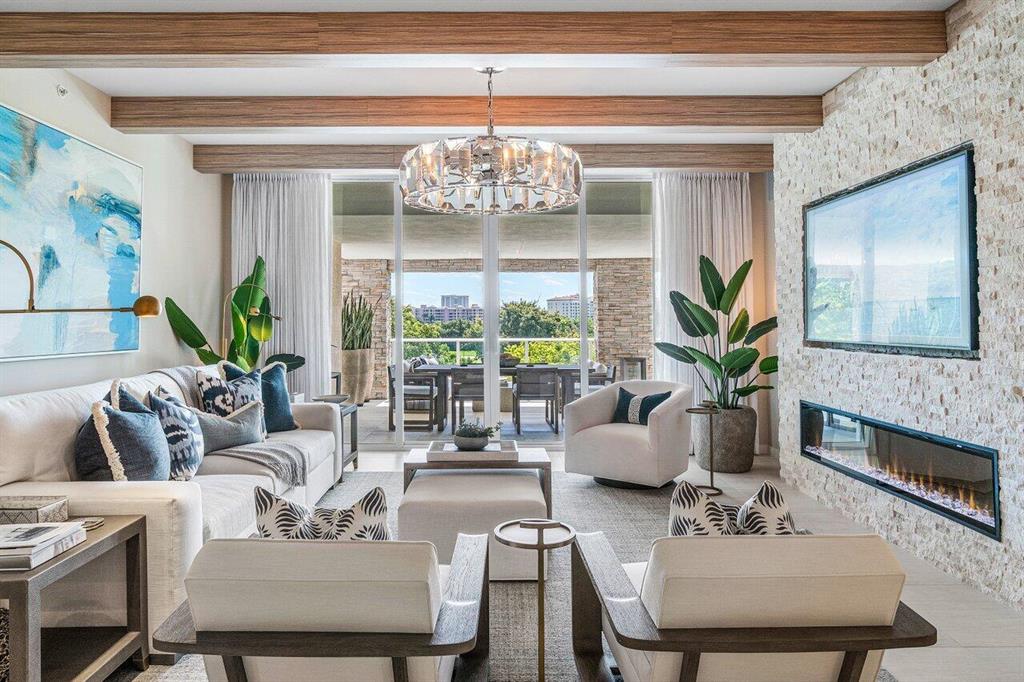 A one-of-a-kind EAST facing residence at Boca Raton's most sought after address. Residence 405 is simply unmatched! The condos' carefully calculated customizations completely enhance its living experience. From the moment you enter this 2-bedroom plus den you will be immersed in style and sophistication. Immediately your eyes are drawn to the oversized loggia overlooking The Boca Raton Resort and then the detailed design elements of wood block beams, custom wall with fireplace & statement light fixtures will capture your attention. The home boasts a never before seen, custom-made, built-in wine tasting room and coffee bar. The open den transcends into a private room with a push of a  button that creates a frosted privacy glass. ALINA's luxury amenity program rivals any 5-star resort.