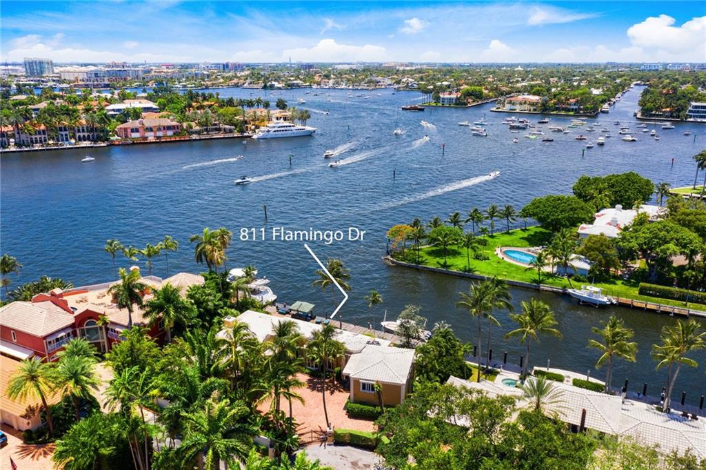 This Palm Beach inspired residence, built in 1951 is located on a premier street off of Las Olas Isles.  Featuring 130' on the water and 105' wide, one in from the point, it is the perfect location to build your dream home.  It has fabulous unobstructed southwest views of the intracoastal and downtown Fort Lauderdale and is just a quick boat ride to the inlet at Port Everglades.  Beautiful arched windows, coffered wood beamed ceilings and a fireplace accent the architectural elegance of this home.  Come see it today, this property should not be missed. Some exclusions apply.