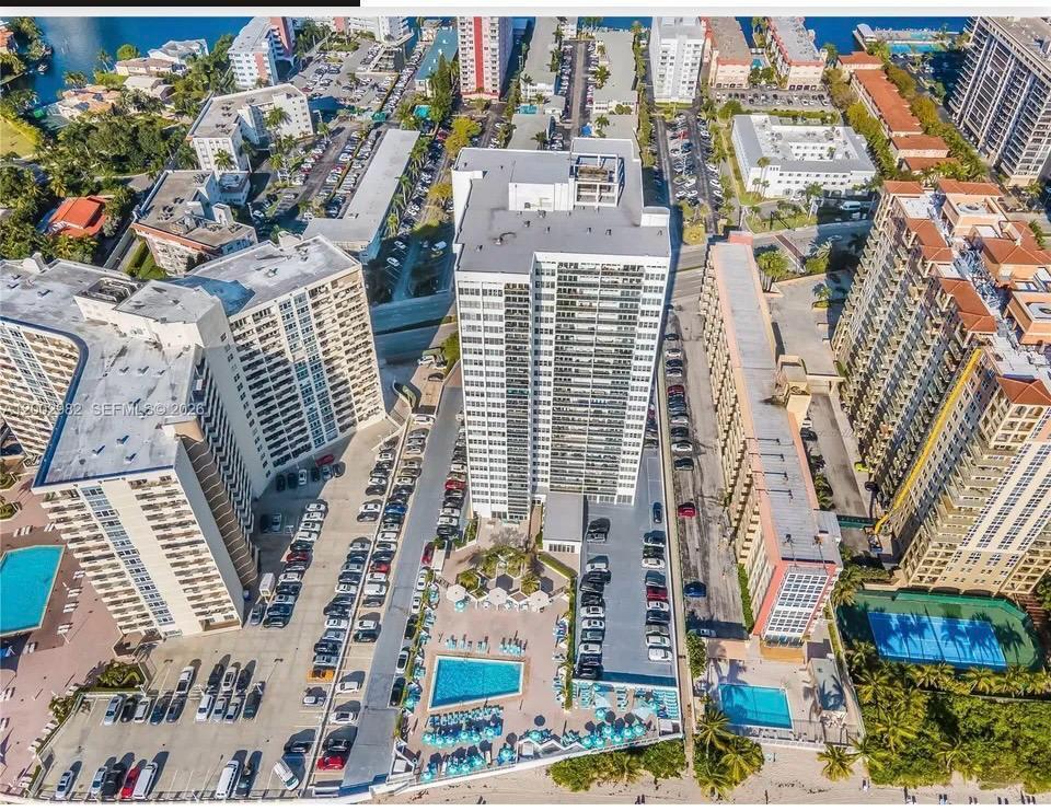 Spacious 2-bed/2-bath condo at Parker Tower, an Ocean Front building in Hallandale Beach, offering an abundance of natural light throughout. Features a kitchen with granite countertops, gas range, and updated stainless steel appliances. Large master suite with two walk-in closets. Tile flooring throughout. Impact glass balcony doors and windows with custom window treatments in all rooms — dual blackout and light/heat shades in bedrooms, rolling shades in the living room. Building central chiller system keeps electric costs remarkably low. HOA covers water, gas, cable, internet, and A/C chiller maintenance. Enjoy breathtaking sunsets and open views from the west-facing balcony.  Resort-style amenities include a heated pool with full beach service, sauna, fitness center, game room, party room with kitchen, and 24-hour concierge/doorman. Building has passed its 40-year certification and features renovated common areas, new balconies, and impact windows throughout. Assigned parking and storage included. Prime location minutes from Aventura Mall, Gulfstream Park & Casino, Publix, and both Miami and Fort Lauderdale airports. Ideal as primary residence, vacation home, or investment property. Live where others vacation!