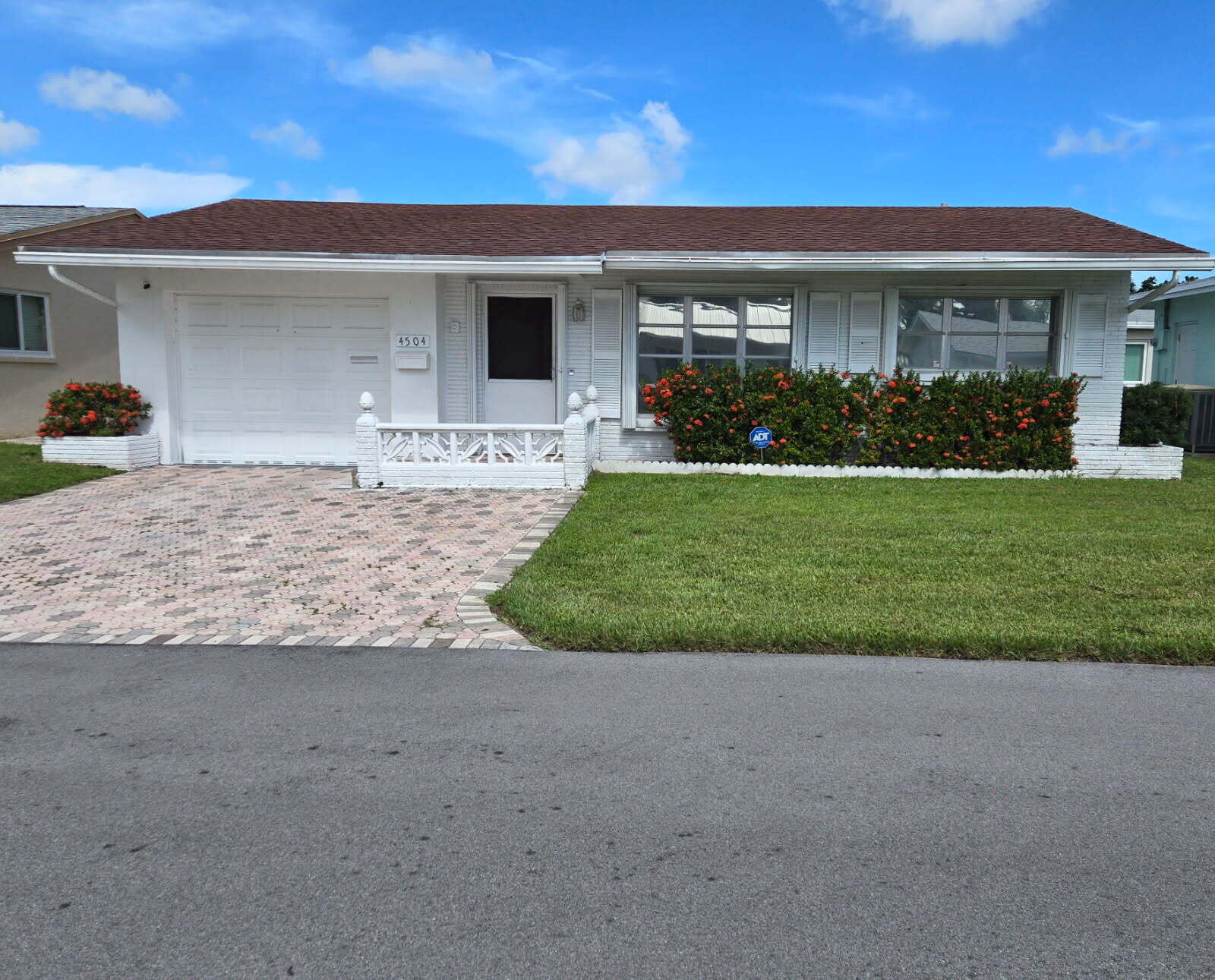 If you are looking for a quite 55+ community, this 2 Bedroom, 2 Bath home is the perfect pick! It is located in the highly valued Mainlands of Tamarac! Easy access to Publix, Shops and Banks In Sunshine Plaza on Commercial and five minutes away from the Florida Turnpike. Property offers manicured lawn with sprinkler systems and paved double parking driveway leading into the enclosed garage with  storage cabinets for those extra items. Washer and Dryer, updated in 2022, are conveniently located in the garage outside of the kitchen with a laundry tub replaced in 2023. Kitchen has stainless steel appliances updated in 2022! New AC and hot water heater in 2023! Accordion shutters on all windows! The home is tiled throughout except for the living room. Master bath updated with a modern vanity and glass enclosed shower with a built in bench. Shower has a beautiful marble design tile to offer a spa-like experience. Home has a patio for grilling and enjoying those beautiful Florida sunny days and breezy nights. The community is great for walking, whether it is by the lake or strolling through the Community. There are lots of amenities that you can enjoy, including the pool, shuffleboard and Club House. There is always something going on in the community room for festivities, activities and more.