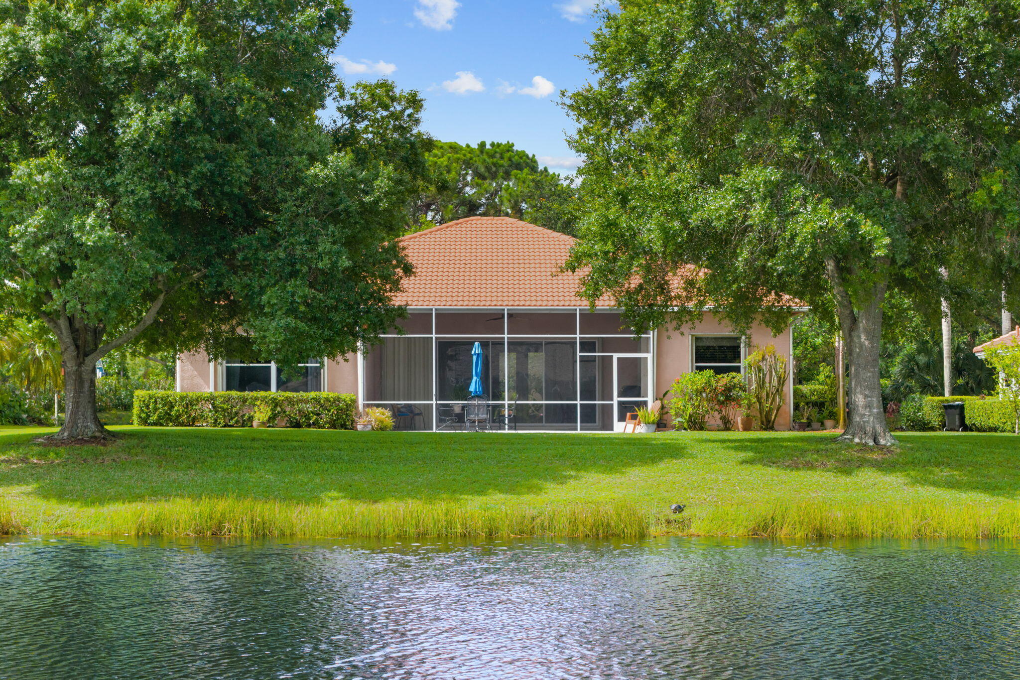 Welcome to this waterfront single-story residence in Country Club Pointe, Port St. Lucie, offering 1,873 square feet of comfortable living space. This three-bedroom, two-bathroom home features a two-car garage and sits on a waterfront lot, providing a unique property experience in this established community. The open layout across one level maximizes functionality and ease of movement throughout the home. Home includes 2 car garage, inside laundry room and screened patio with natural gas hookup for BBQ grill. This home comes complete with accordion shutters, gas water heater new in 2025 and AC in 2023. HOA dues include basic cable, internet and security guard gate.