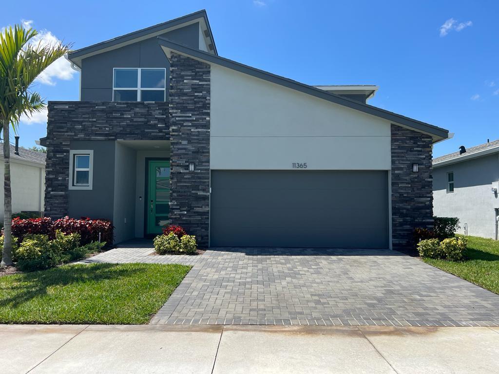 Welcome to this beautifully upgraded 4-bedroom, 2-bath, two-story home located in the highly desirable community of Tradition. Built in 2022, this modern residence combines contemporary design, and upscale finishes within a secure gated neighborhood. Step inside to discover a bright open-concept floor plan featuring spacious living and dining areas, designer lighting, upgraded flooring, and a chef-inspired kitchen with premium cabinetry, quartz countertops, stainless steel appliances, and an oversized island perfect for entertaining. The home offers generous bedrooms, Loft, flexible living space, and thoughtfully selected upgrades throughout. Move-in ready and better than new, this exceptional home is a rare opportunity to enjoy modern Florida living at its finest.  Designed for comfort and peace of mind, the property includes full impact-resistant windows and doors, providing enhanced storm protection, energy efficiency, and added security. The two-story layout offers ideal separation between living and private spaces, making it perfect for families, guests, or a home office setup. Enjoy outdoor living with a beautifully maintained yard and access to resort-style gated community amenities that include a clubhouse, pool, fitness center, walking trails, parks, and more. Conveniently located near shopping, dining, medical facilities, golf, and major highways, this home offers the perfect blend of luxury and lifestyle in one of Port St. Lucie's fastest-growing communities.