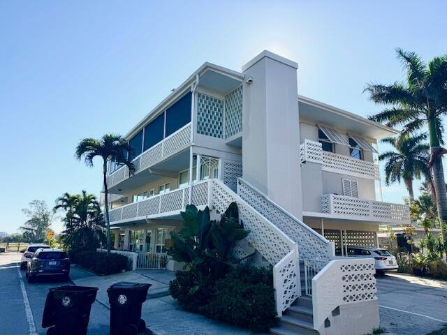 Located in the Parrot Cove neighborhood of Lake Worth Beach. This spacious 3BR/3BA residence is located in a 5-unit condominium building adjacent to a golf course and the Intracoastal Waterway across the way. Thoughtfully designed floor plan features an oversized primary suite, with guest bedrooms positioned on the opposite side of the unit for added privacy. The kitchen and living areas are centrally located, creating an open and functional living space. Additional features include an in-unit washer and dryer and two spacious balconies that provide inviting outdoor living areas. Well-maintained , this home offers a relaxed atmosphere. Enjoy beautiful sunrise views over the water, fishing across the street, nearby parks, and frequent community festivals.  Conveniently located within walking distance  or short drive to downtown Lake Worth Beach, offering dining, shopping, entertainment, and waterfront recreation.