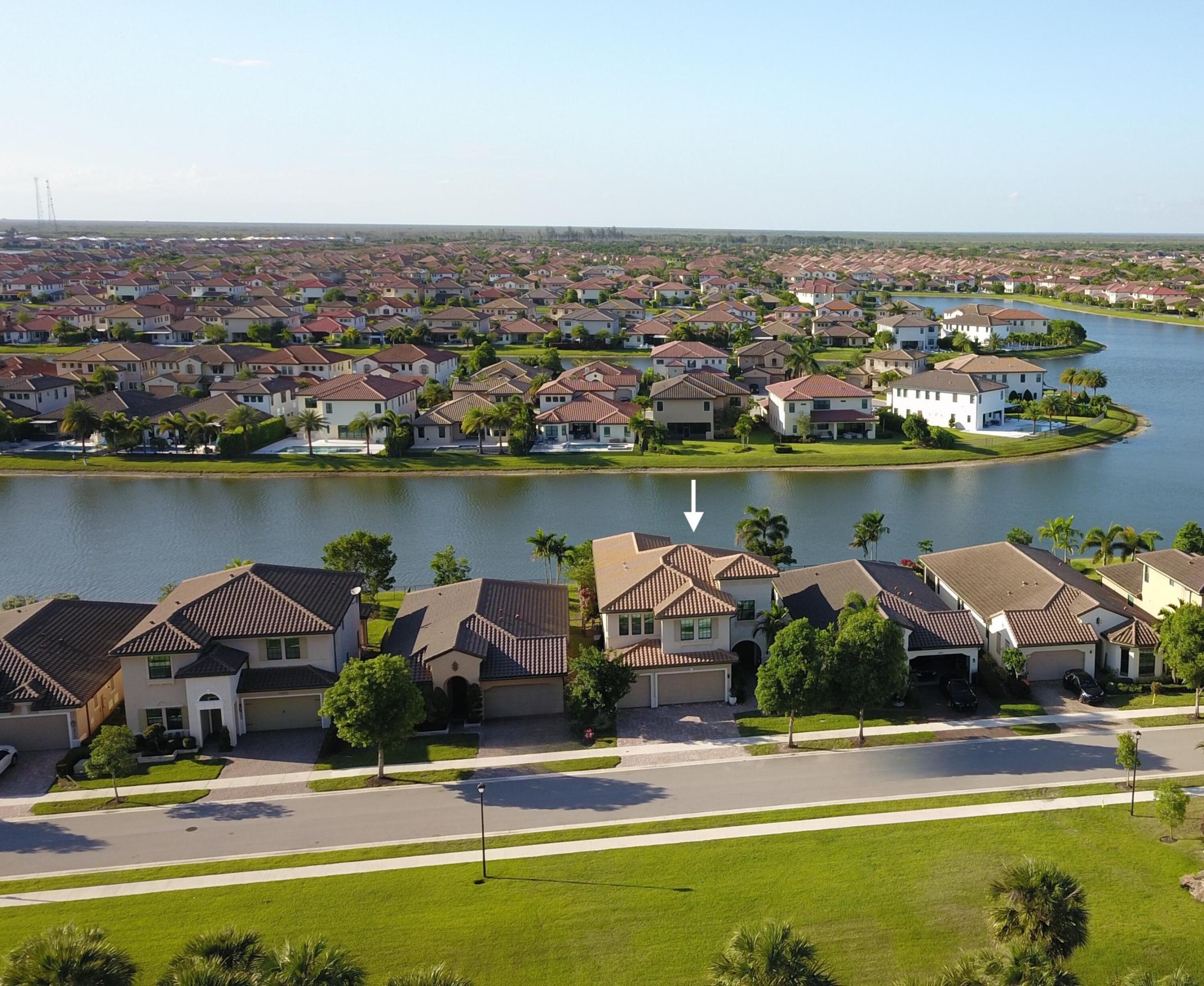 Exquisite former model home recently built in 2018 located on a prime lakefront lot and No front neighbors in the prestigious and exclusive Parkland Bay community, This Extended Tern model has the additional huge game room built out upstairs with almost 4,100 sq ft of living space. It features a beautiful pool overlooking breathtaking lake views, a large covered patio, impact windows and doors, 1 bedroom and full bathroom downstairs and upstairs are the Master bedroom and 3 other bedrooms plus the game room, beautiful large format polished porcelain tile and wood floors in living areas, upgraded kitchen, upgraded bathrooms, upgraded smooth walls, designer room darkening shades, and many more upgrades!  Parkland Bay is a guard-gated community featuring a 16,000-sq-ft clubhouse, resort-style pool, gym, tennis, basketball, cabanas, playground and more!