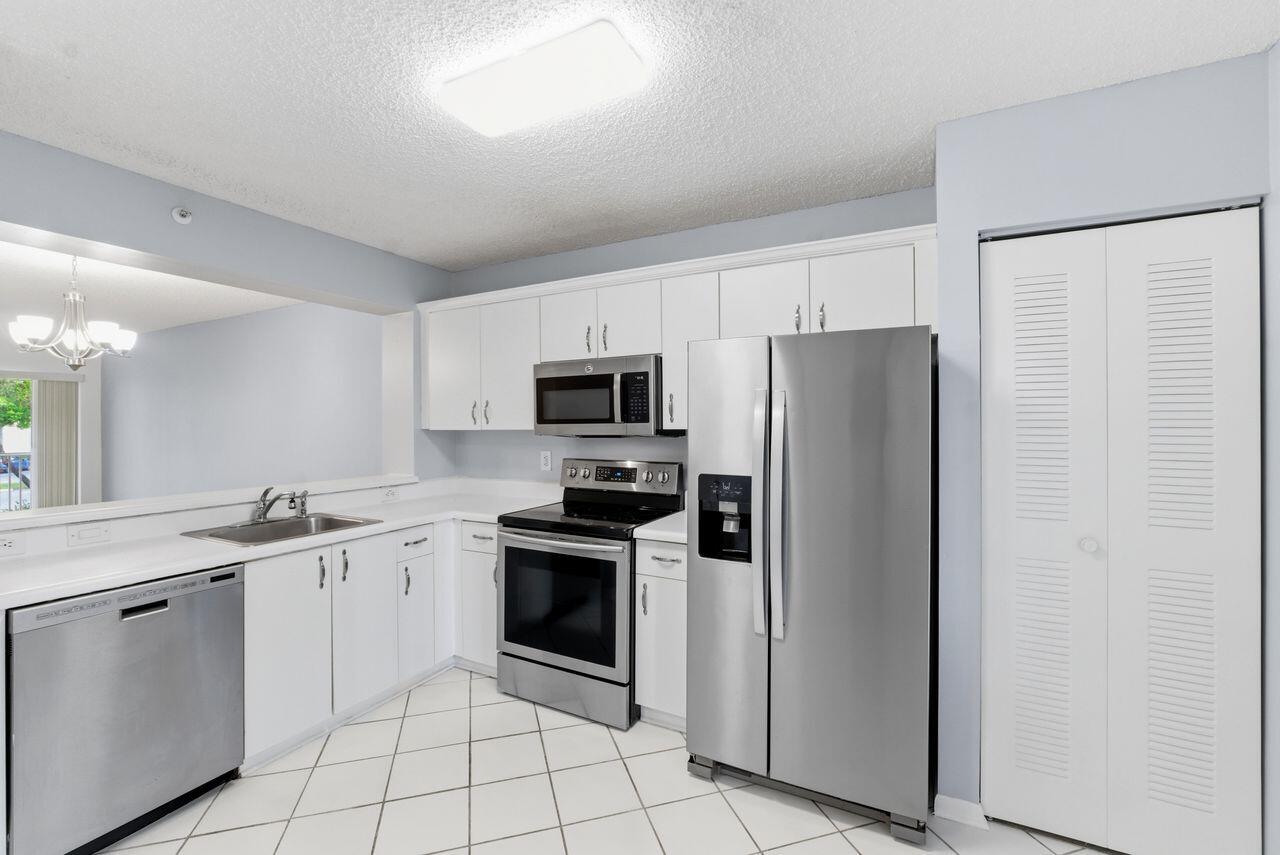 Beautiful renovated 2 bedroom and 1 1/2 bath, desired corner unit steps away from elevator, beautiful floors, spacious kitchen & living room, all appliances included W/ Washer and Dryer in the unit. Condo offers many amenities: pool, tennis, gym, billiards and more with fabulous club house, theater, courtesy bus. Per association adult community. Gated community. Association includes; water, pest control, gate security, garbage, cable and internet. Ready to move in !