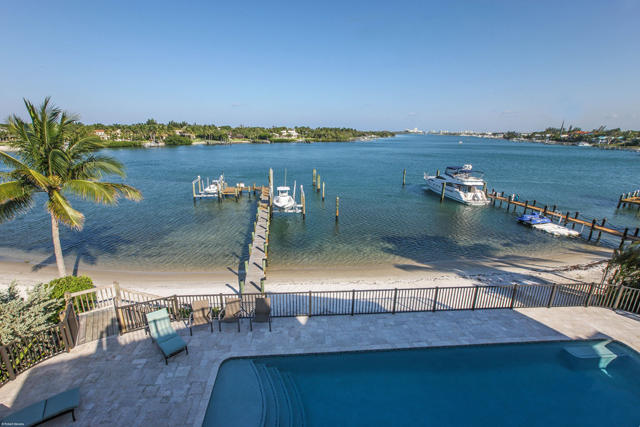 INTRACOASTAL PROPERTY - Over 100' of Direct Intracoastal Frontage - blue water for as far as your eyes can see. Dockage for a 100' boat plus another dock for a boat and/or water toys... this property is for all water lovers.  Relax and take in the beautiful Florida Lifestyle in the comfort of your own home. This home was renovated in 2014 which included a new metal roof, new pool & spa, all impact windows and doors, new travertine and wood floors, new outdoor deck with Travertine, new guest baths. Enchanting master bedroom with fireplace, french doors to take in the long water views, luxurious his/hers bath, large closets a true retreat. 4 large guest suites with private baths, elevator, 3 car garage, gated entry and much much more.