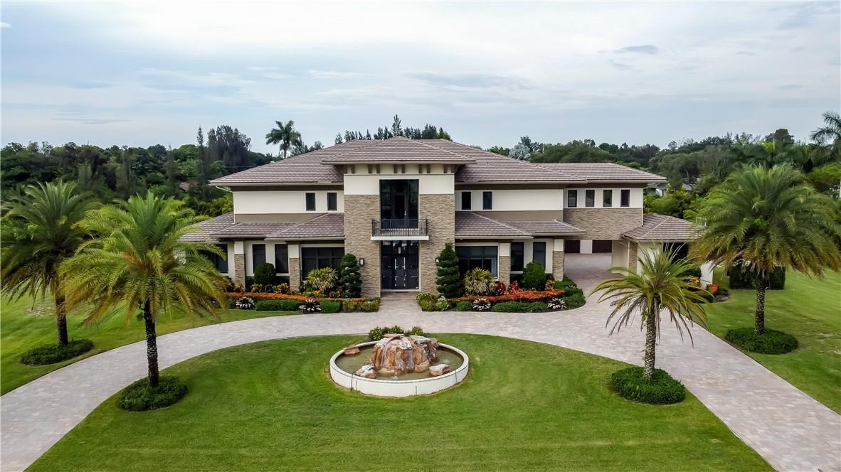 Custom Built Luxurious Estate in SW Ranches. Designed by the renowned Clive Daniel, the interior and exterior features exquisite finishes, artwork, and furniture, all included in the sale except for personal items. Entering to a Double Grand Glass Staircase with views through the great room to the tropical paradise backyard with rock waterfall. Also on the 1st floor is 2 Bedrooms with ensuite, Theater room, Office with Prayer/Gym, Billiards with Lounge room, and Family Room with Kitchen. Take the Elevator to the 2nd floor where the expansive Master Bedroom and 2 Guest Rooms with ensuites feature Steam Rooms in the Showers. Complete Home Sound,Camera, & Generator are just a few of the many features this estate includes. This 2.43 Acre luxurious contemporary estate is a true masterpiece!