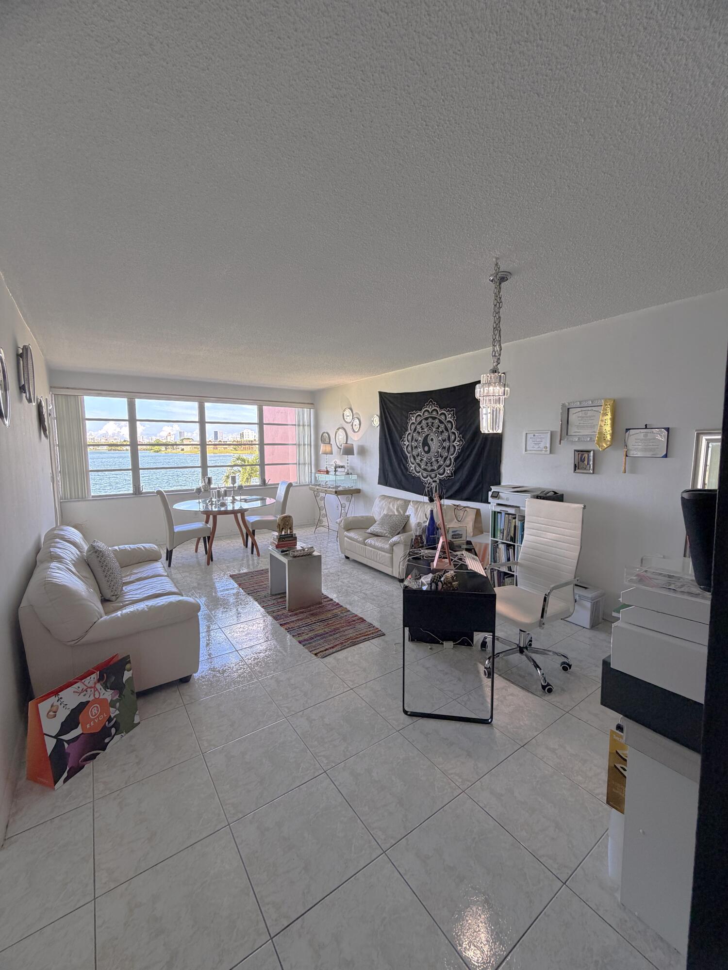 Stunning lake view waterfront 1 bed with 1.5-bathroom on second floor, in the desirable 55+ Sixth Moorings community of North Miami Beach with strong financial association reserves close to $200K. New 2023 A/C with 3 new front impact windows. Open floor plan with clean tile flooring with serene lake views from your enclosed patio. Spacious layout with a large primary suite with a huge walk-in closet and a private full bathroom. It also has a half guest bathroom off the main living area. Recoated roof has a 12-year warranty. The community amenities include 2 sparkling pools, a fitness center, a clubhouse, private laundry room per floor, elevators, 5x5 storage and assigned parking. No pets or immediate rentals per HOA rules. Minutes to Aventura Mall, Skylake Center, and 1-95, and beaches!