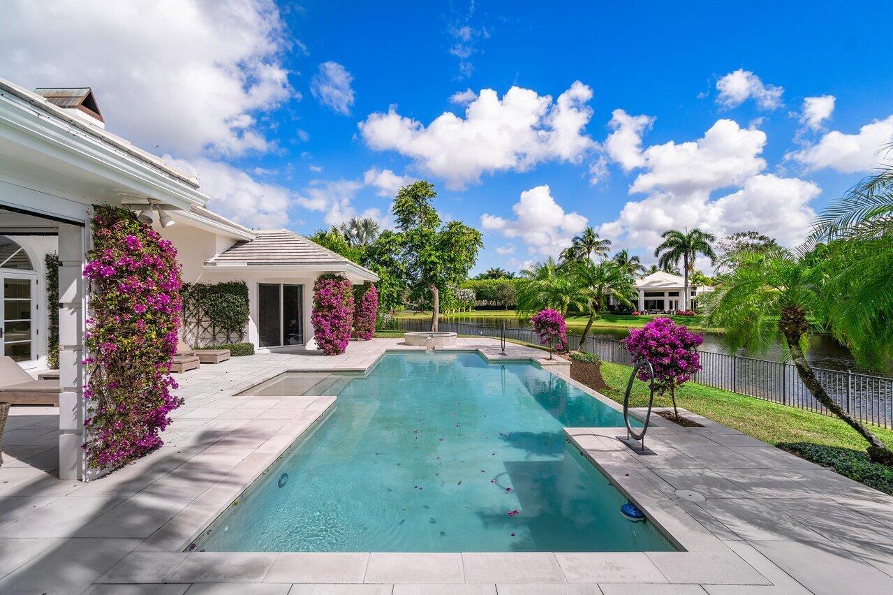 Seller motivated! Welcome to your dream home! Arguably the best location in Wellington adjacent to the Equestrian showgrounds. This stunning 4 bedroom, 4.5 bathroom estate boasts breathtaking views of a serene lake and features an heated pool & spa perfect for relaxing or entertaining guests. The spacious and airy interior of this home has been expertly designed with the finest finishes and attention to detail. The modern kitchen is equipped with high-end stainless steel appliances and ample counter space, making it perfect for hosting dinner parties or cooking gourmet meals for your family. Each of the 4 bedrooms is generously sized and features its own ensuite bathroom, providing both comfort and privacy. The master suite is especially luxurious, featuring a spa-like bathroom with a soaking tub, a separate shower, and a walk-in closet. Located just stones away from WEF