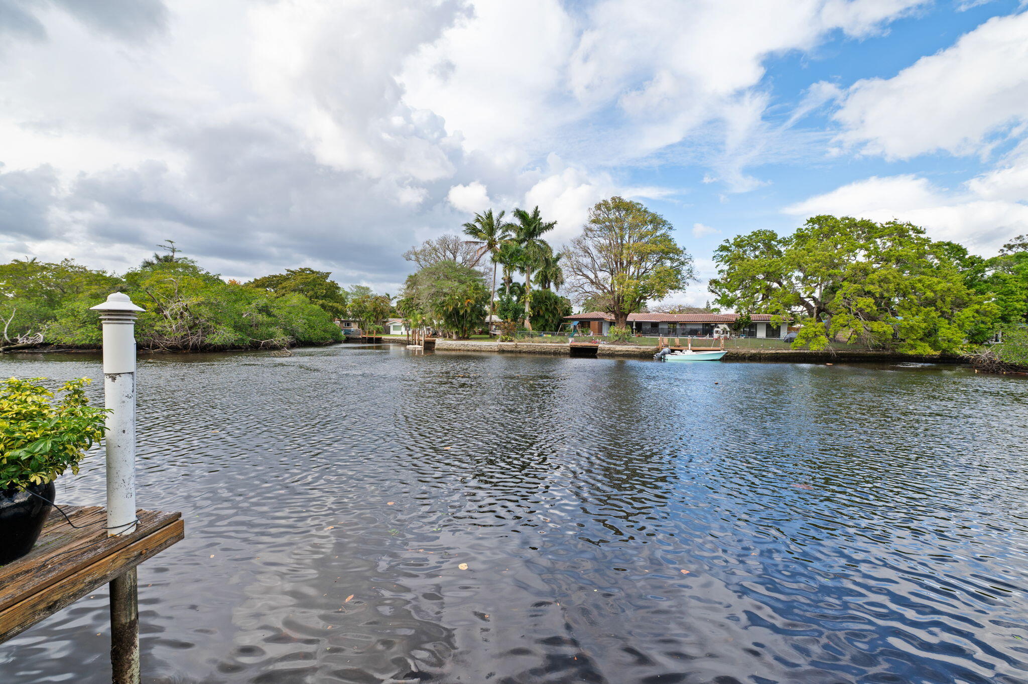 This tranquil waterfront oasis is for the those that desire a relaxing and peaceful lifestyle. The wide views of the flowing Middle River provide an experience seldom found in SOFL.  It is an oversized property for the area and offers a terrific wide open floor plan with the kitchen, living, family and dining areas all offering walls of glass out to the water. The classic and neutral terrazzo flooring can be restored to its original beauty. The primary bedroom offers excellent dimensions and an immense ensuite bathroom.  The exterior is an entertainers delight with the newer pool and travertine deck all set up for maximum exposure to the river. Other benefits include the PVC drain lines, newer AC's, pool heater, termite warranty, carport, impact windows and doors, new window treatments, new pool pump and rebuilt heater. Sit on the dock, by the pool, in the screened Florida room or in most interior rooms and be mesmerized by the ever changing scene of the beautiful waterway. Watch the wildlife, fish or kayak the Wilton Manors loop for the ultimate naturalistic way of life.  This home is perfectly situated on a very quiet less traveled street but walking distance to Wilton Dr and the entertainment district.