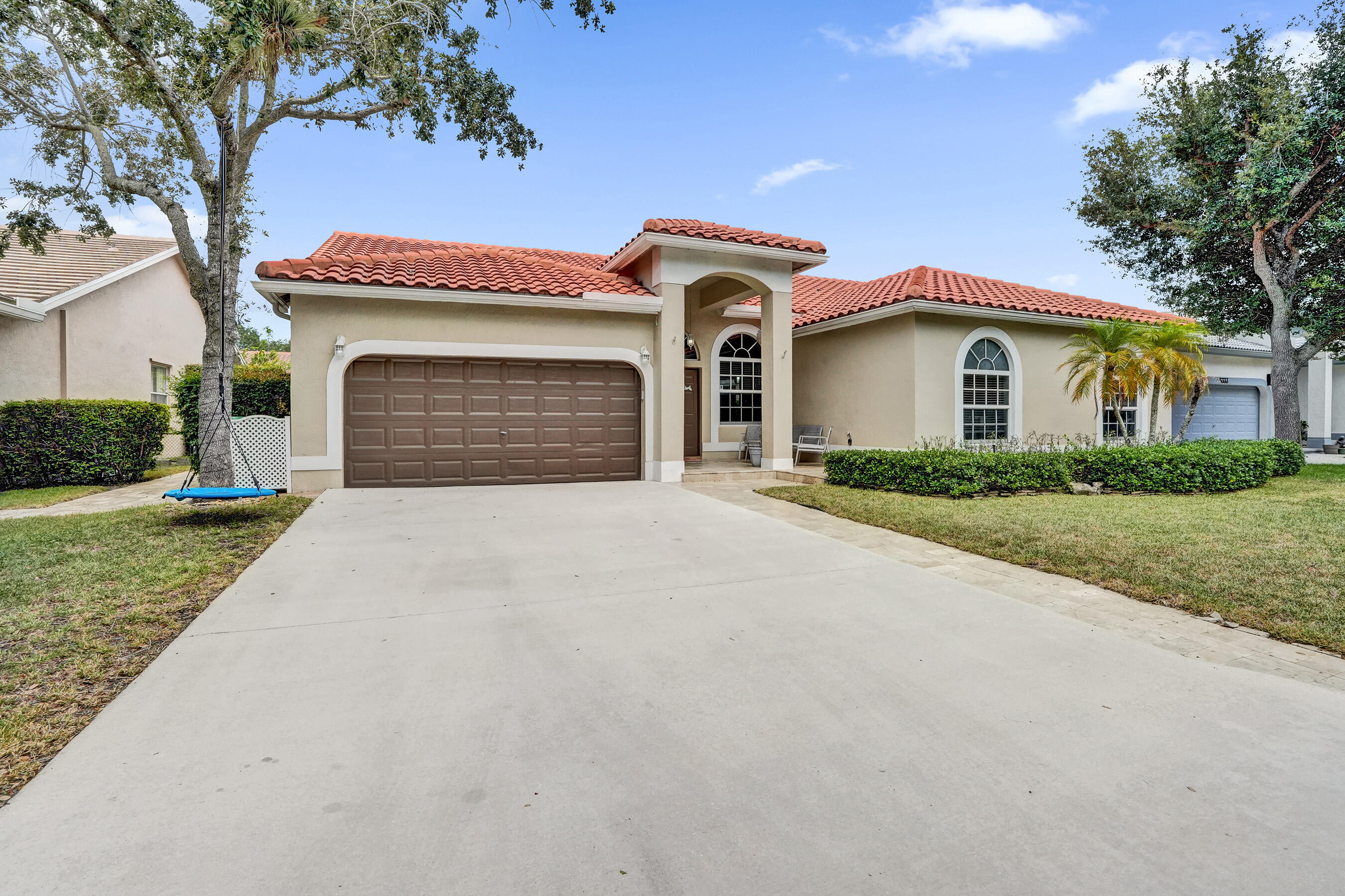 Welcome to this stunning 4-bedroom, 2.5-bathroom single-story oasis in the Coral Creek community of Coral Springs, featuring 2,550 square feet of living space, soaring volume ceilings, and a highly desirable split floor plan. A beautifully updated kitchen and seamless interior flow directly to a spectacular, resort-style backyard designed for year-round Florida living. Entertain effortlessly under the expansive screened-in patio, cook up a feast in the equipped outdoor kitchen, or relax under the tiki hut before taking a dip in the sparkling pool and attached spa. Complete with a two-car garage, this beautifully proportioned, well-maintained residence presents an incredible opportunity to experience the ultimate South Florida lifestyle.