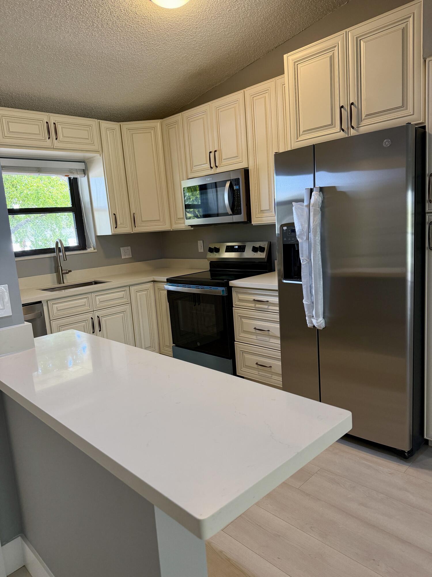 Gorgeous, renovated 2+2. New cream kitchen cabinets with quartz countertops & new stainless steel appls (refrigerator, oven, washer). Gorgeous Master bathroom. New large plank LV  flooring entire unit (no carpeting).  New doors.  Walk-in closet in master w.built-ins. Waterfront with beautiful lake view. Full-size washer/dryer in unit. Hurricane shutter on balcony, Pet and rental friendly community. Great east Boca location in gated community with 24hr security, 2 pools/clubhouses, tennis, racquetball & basketball courts, walking trails, dog park, picnic & BBQ areas and much more! Adjacent to I95 & FAU/PBSC and just a quick drive to the beach, Lynne U, Town Center Mall, and Mizner Park.