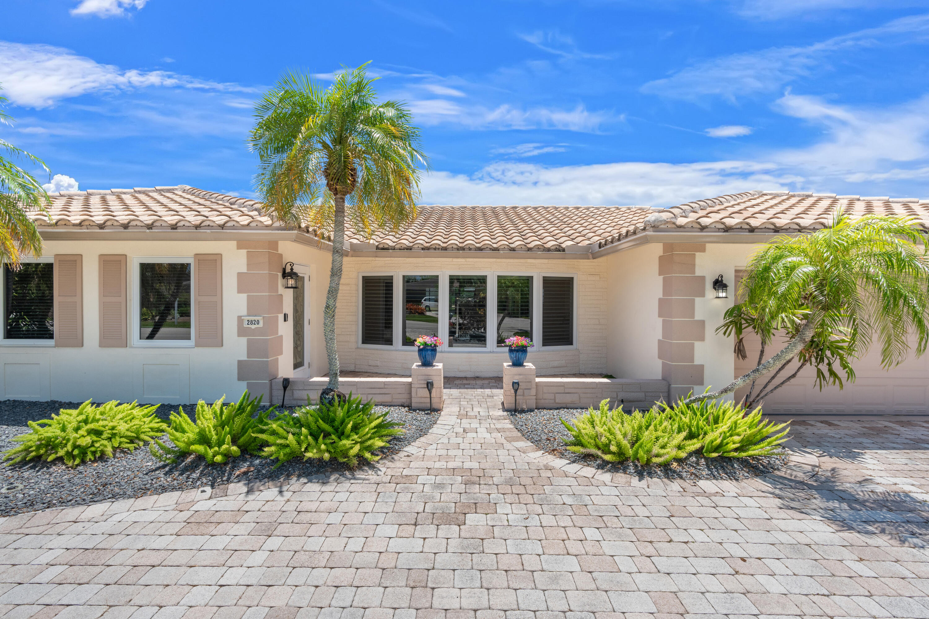 Boater's paradise with 75 feet of waterfront on a 100-foot-wide canal and a new seawall/dock completed to current code in 2020. This welcoming 3-bedroom, 2-bath home features porcelain tile throughout, including a cabana bath ideal for pool access. Top-of-the-line PGT impact windows and pocket sliding glass doors provide abundant natural light and seamless indoor-outdoor living. Interior features include plantation shutters and custom window coverings. The spacious south-facing patio area offers a private backyard setting with a pool and custom built-in infrared gas grill, perfect for entertaining. Additional upgrades include over $60K in solar panels, oversized 2-car garage with impact garage door, beautifully landscaped front yard with sprinklers & a low-maintenance astro-turf backyard.