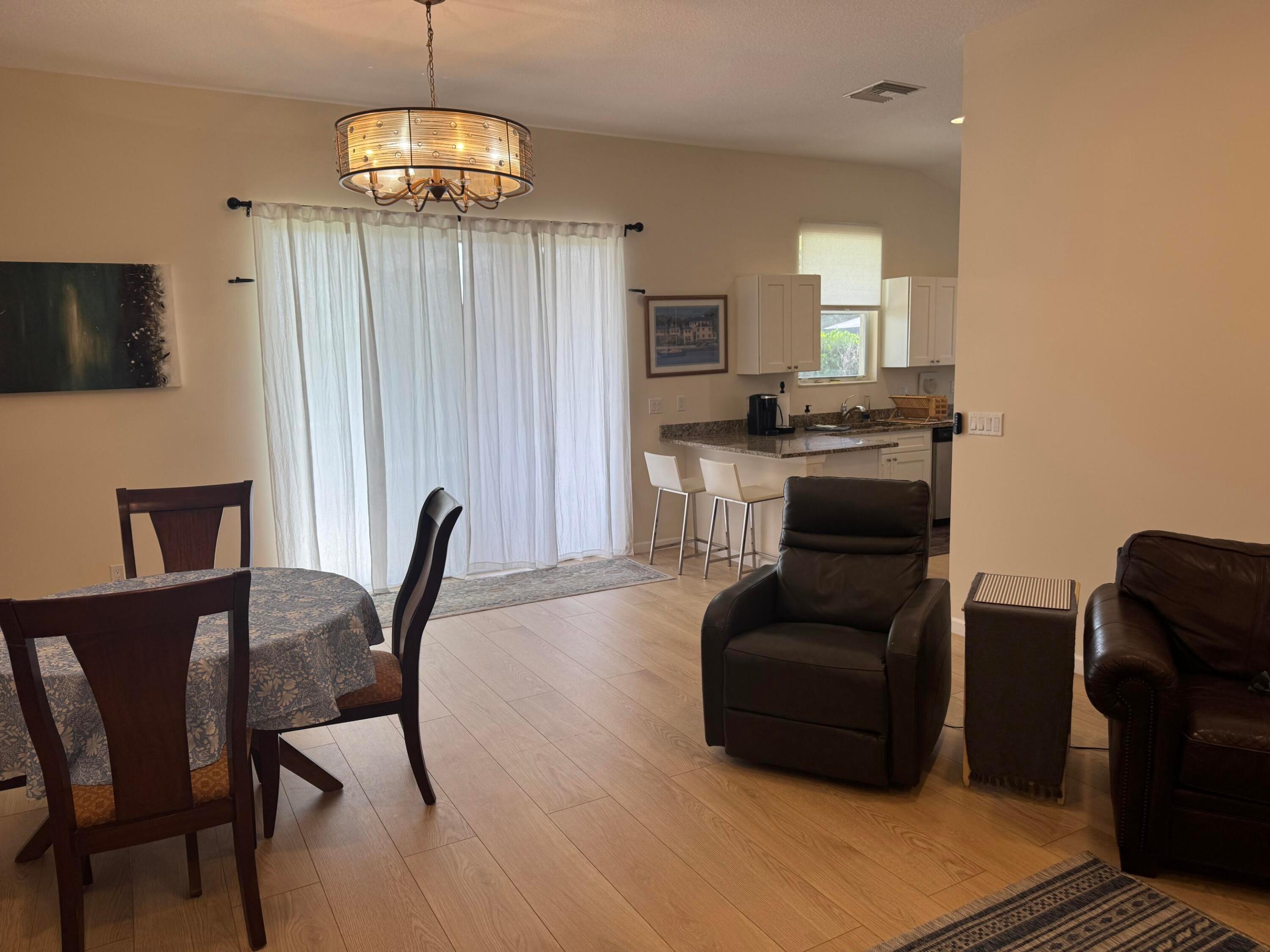 Welcome to this thoughtfully designed one-story home in Pettway Park, Hobe Sound, offering 1,939 square feet of comfortable living space. This four-bedroom, two-bathroom residence provides plenty of room for versatile living arrangements, whether you need dedicated spaces for work, hobbies, or guests. The two-car garage ensures convenient parking and additional storage for your vehicles and belongings. Located in the established Pettway Park community, this property combines practical floor planning with accessible single-level living. Non-HOA community.  High ceilings, open and airy.  Currently used as an Airbnb