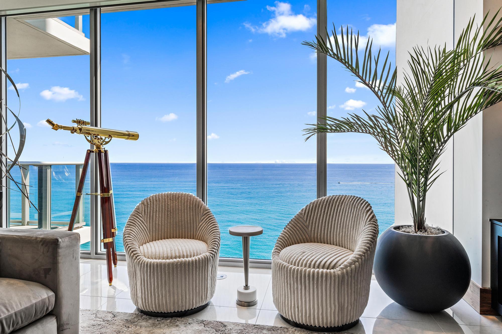 4,000+ sq. feet of paradise in the sky located at the prestigious 5000 N Ocean Drive~ Directly on the sand! This residence is fully furnished and turnkey ready. Condominium has been completely customized like no other in the building. Some key characteristics include custom inlay walnut doors with stunning double entry doors, commissioned jellyfish artwork installation, tailor-made kitchen and bathrooms with customized granite island and waterfall, special lighting and fixtures all on a Control4 operating system allowing access from your phone anywhere in the world! Automated blinds throughout, made to order decorative sound enhancing ceiling with surround-sound in every part of the residence. Multiple built-ins including entertainment wall and floating shelves with so much more! This highly sought after Seabreeze residence provides stunning intracoastal and ocean views. Step off the access-controlled elevator into your private vestibule. Great room floor plan offers 3 spacious bedrooms, family room, and 4.5 baths, soaring 9'10'' ceilings with full height sliding glass doors and windows. Multiple oversized terraces with glass panel rails add a welcoming outdoor living area with unobstructed water views. The amenities of 5000 North Ocean offer sophisticated luxury living, oceanfront fitness center and resort-style pool. Property is a must see and easy to view; call today for your private showing! Singer Island is conveniently located in Northern Palm Beach County and offers an abundance of local amenities including nearby shopping at the luxurious Gardens Mall and world-renowned Worth Avenue, golfing at the North Palm Beach Country Club, along with numerous top golf communities in Palm Beach county.  Singer Island offers a plethora of water sports such as world-class snorkeling, scuba diving, sailing, jet-skiing, kayaking, paddle-boarding, and some of the best fishing in South Florida, all with easy access to Palm Beach International Airport!