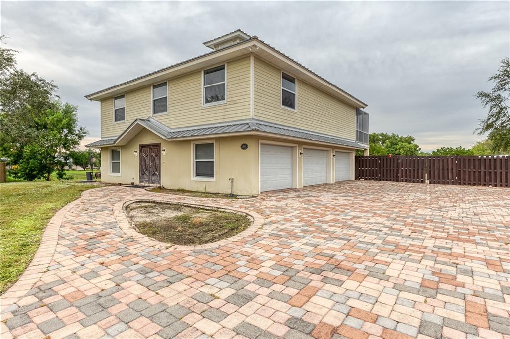 Contemporary spacious family home built in 2004 with metal roof on large lot with triple garage.  Unique layout with Master Suite upstairs and 2 bedrooms & bath downstairs.  Screened balcony overlooks the large yard with covered patio below.  Two zone A/C for maximum efficiency and installed recently.  Great location near Savanna Preserve State Park.  NO HOA