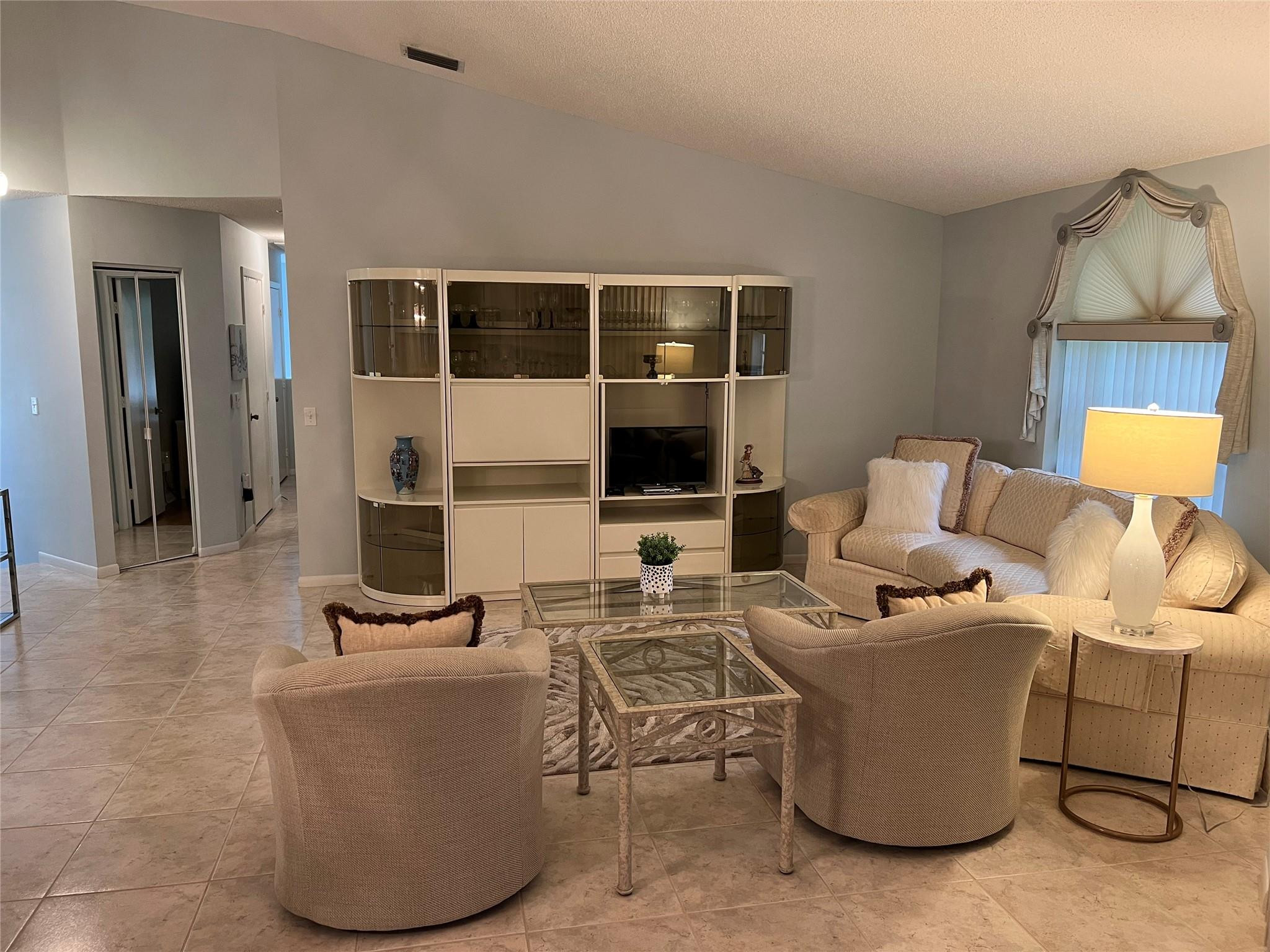 Discover this fully furnished Grandi Model, in Platina's Lucente Village—a sanctuary perfect for blissful Florida vacations or year-round living. Upon entry, choose between a chic private staircase or your own elevator, whisking you up to an expansive, sunlit living area that breathes warmth and openness. Your culinary haven of a kitchen offers ample storage and a cozy breakfast nook. Retreat to the master suite, boasting a spacious walk-in closet and a lavish bathroom with dual sinks, a Roman tub, and a large walk-in shower. Guests will adore the two additional bedrooms, strategically placed next to a second full bathroom for optimal privacy. Complete with a glass-enclosed patio for serene outdoor moments, this condo is your ticket to a luxurious lifestyle. This delightful residence comes imbued with the love and care of its previous owners, setting the stage for you to adore it just as much! Discerning homebuyers consistently rank Platina as a top-tier choice, and for good reason. Here, you'll indulge in resort-style living that knows no equal, where your condo fees generously cover AT&T Fiber Optic High-Speed Internet, external pest control, roof upkeep, and even water.Step into our newly renovated, 20,000-square-foot clubhouse—a true marvel of design and amenities. From a charming café serving breakfast and lunch to versatile card rooms and a state-of-the-art fitness center, your leisure options are endless. Picture yourself cycling in our solarium, with panoramic views of our stunning pool area!Choose between intimate satellite pools or our grand, free-form main pool with an expansive sundeck. Tennis, handball, and pickleball courts invite active lifestyles, while an art room complete with a kiln stokes your creative fires. With a vibrant social calendar featuring shows, bingo, and an array of clubs, there's never a dull moment.Rest assured in the security of a 24-hour guard-gated community, superbly positioned for easy access to I-95 and the Florida Turnpike, and within close proximity to premier shopping and delectable dining options. Don't miss out—make sure to tour our extraordinary clubhouse as part of your Platina experience!