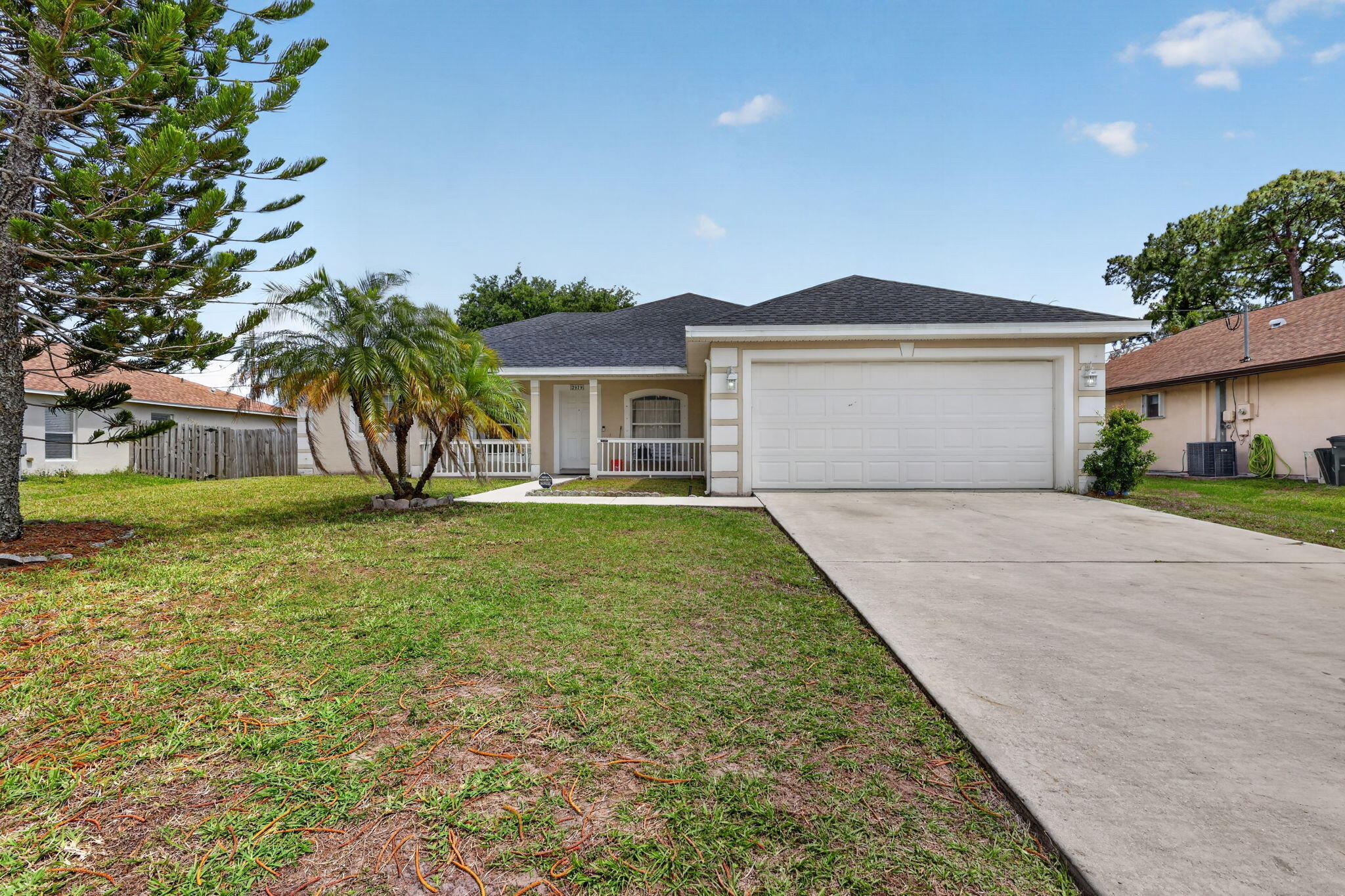 Spacious and well-maintained 4-bedroom, 2-bathroom home with a bonus flex room, perfect as a nursery, home office, or den, and NO HOA. A brand new 2024 roof means one of the biggest ticket items is already done, giving you real peace of mind before you even move in.From the moment you arrive, the inviting front porch sets the tone with great curb appeal and a warm first impression. Inside, vaulted ceilings open up the living spaces, and tile and vinyl flooring throughout means zero carpet and easy upkeep.  The primary suite is built to impress, with a separate whirlpool tub and shower, dual vanities with his and her sinks, and two walk-in closets. A spacious laundry room rounds out the everyday convenience this home delivers. Out back, the fully fenced yard features a large mature tree for natural shade, an outdoor shed for extra storage, and plenty of space to relax or entertain. All of this in a location with quick access to the Florida Turnpike, putting commuting, shopping, and dining right at your fingertips. Priced right for everything it offers.