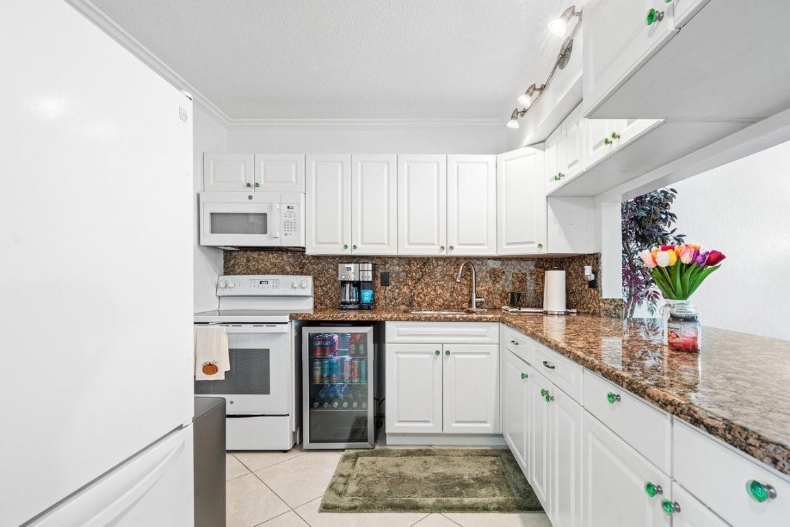 Welcome to this truly move-in ready condo in a great location in West Boca. This spacious unit offers a large, updated kitchen, tile throughout and a full sized washer & dryer. The windows are impact rated not including the sliding glass door which has storm panels for protection. A peaceful and large screened in balcony gives you a great area to unwind with tons of privacy and water view. Located close to major highways, top rated schools, public parks and nearly unlimited restaurant options!