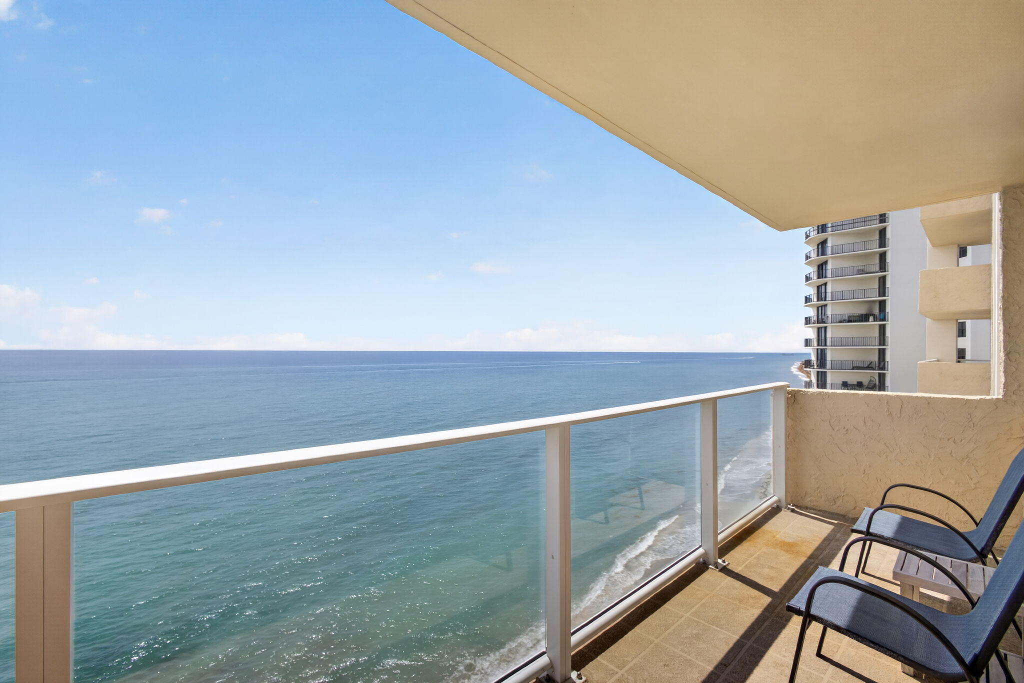 Spectacular Ocean Front Living on Singer Island. Enjoy breathtaking panoramic views from this exceptional condominium featuring a 37-foot wraparound balcony overlooking the turquoise Atlantic Ocean by day and the glittering night lights of the Intracoastal Waterway by night.  This residence has been fully upgraded and showcases impact windows and sliders throughout, smooth ceilings, and elegant porcelain tile flooring. The open-concept kitchen is designed for both beauty and function, offering custom cabinetry, a striking quartz center island with seating , and seamless flow for entertaining. A washer and dryer are conveniently located in-unit, and spacious walk-in closets provide excellent storage.And most important miles of sandy beach at your footsteps. Building amenities include a fitness center, clubroom with full kitchen ideal for gatherings, resort-style pool, and covered parking. Ideally located just 15 minutes to the airport and within walking distance to restaurants and entertainment.  And most importantly   miles of pristine sandy beach are right at your footsteps. Bitcoin Accepted for purchase.
