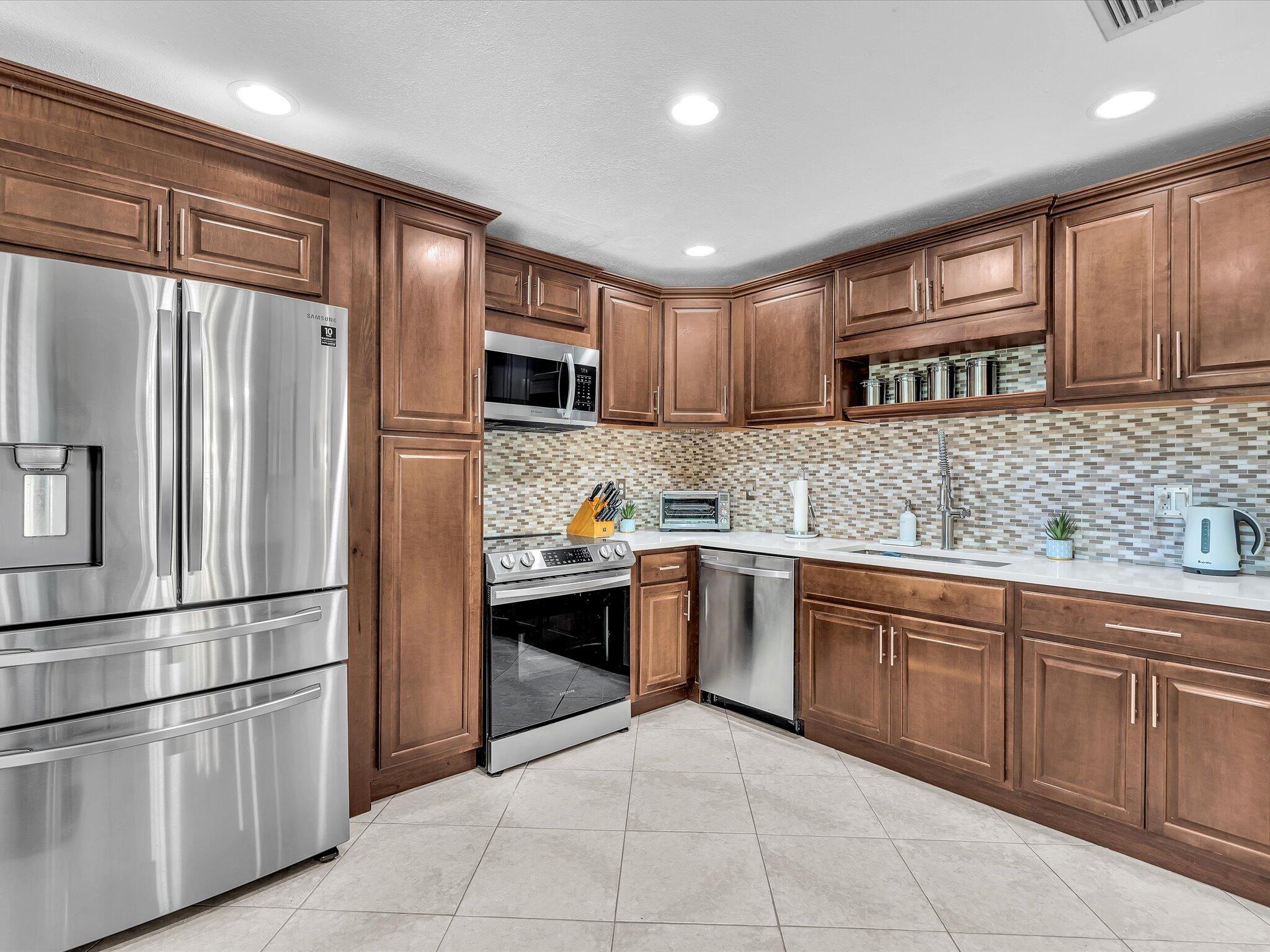 Move right into this beautifully updated, 1st floor, 2 BR, 2 BTH condominium in the desirable Boca Ridge community. Thoughtfully designed with 1,475 square feet of living space offers an open, comfortable layout with stylish updates throughout. The renovated kitchen features modern cabinetry, quality finishes, and ample workspace. An enclosed patio provides valuable additional living space that can be used as a home office, or sunroom, while the separate outdoor patio offers the perfect spot to relax or entertain. The spacious floor plan provides privacy with two bedrooms and two full bathrooms, making it ideal for year-round living or a seasonal retreat. The roof was recently replaced with exterior insurance included in the low HOA.  Ideally located in the heart of West Boca Raton, you'll enjoy easy access to everyday conveniences including shopping, restaurants, grocery stores, parks, and major roadways. Just minutes from Town Center at Boca Raton, Uptown Boca, South County Regional Park, Florida's Turnpike, and top-rated Palm Beach County schools, with easy access to both Palm Beach International and Ft Lauderdale airports, this location offers the perfect balance of convenience and lifestyle.