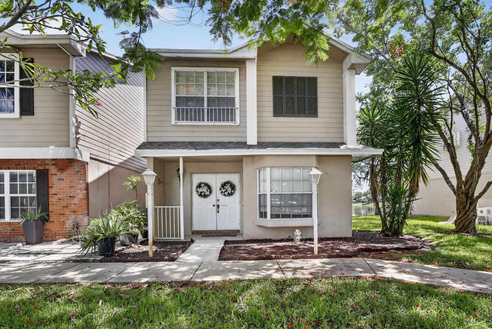 Experience serene lakefront living in this beautiful two-story townhome in Colony Courts. This 1,388sqft residence features two spacious primary suites w/ vaulted ceilings. The open main level connects the living and dining areas to an inviting eat-in kitchen with custom built-ins. Enjoy tranquil water views from your private patio or a short walk to the community pool. Ideally located for convenience, the property offers quick access to the Sawgrass Expressway and I-75. You are minutes from Sawgrass Mills Mall, upscale dining, Amerant Bank Arena, and local parks. One assigned parking space is included, with ample guest parking nearby. This community is ideal for both residents and investors with no rental restrictions for immediate leasing. The perfect blend of location, comfort, & value!
