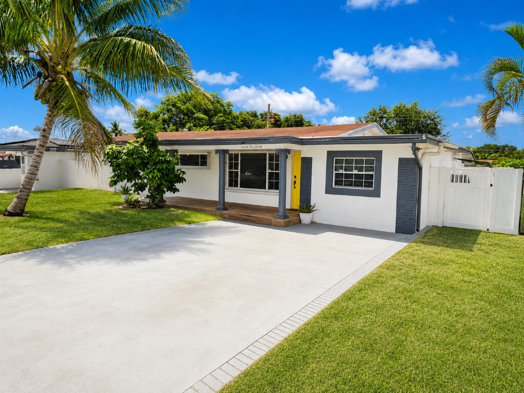 Move in Ready!  Great new Turf on a large portion of the back yard. Enough parking for all your toys, boats, golf carts and Rvs. City currently working on connections to the water and sewer system, a great update for the area. Roof is from 2019, the house is well kept and in great condition. A standout feature of this home is the private mother-in-law room with a separate entrance, full bathroom and counter for anyone's favorite tea. This flexible space is ideal for extended family, visiting guests, or anyone who would benefit from added privacy and independence. This single-story ranch-style home has a bright, comfortable South Florida feel with updated interiors and a spacious outdoor living area. The home features an open living, dining, and kitchen layout with modern tile flooring, neutral finishes, and plenty of natural light. The kitchen connects well with the main living area, making the space feel open and practical for everyday living or entertaining. The bathrooms have modern tile, glass shower enclosures, sleek vanities, and a clean neutral design.  Outside, the home offers a large driveway, tropical landscaping with palms and fruit trees, a welcoming yellow front door, and a private backyard with a pool, covered patio, turf area, outdoor seating, and room to relax or entertain. Come see this Slice of Paradise!