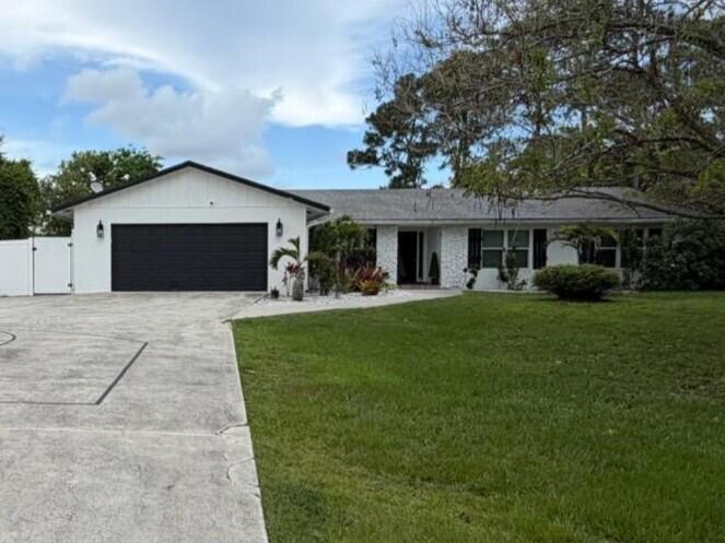 Welcome to this beautifully updated 4-bedroom, 2.5-bath home in the highly sought-after, non-HOA community of Jupiter Farms. Designed for both everyday living and effortless entertaining, this home features a spacious open-concept floor plan centered around an oversized kitchen island, complete with white quartz countertops, stainless steel appliances, a wine/beverage refrigerator, and abundant storage.  Enjoy seamless indoor-outdoor living with passthrough windows to the pool area, a bright sunroom perfect for a home office or flex space, and a large backyard ideal for gatherings. The private primary suite offers a relaxing retreat with a Jacuzzi tub and updated finishes.  Additional highlights include a large storage shed complete with electric, ample parking for vehicles, boats, or recr eational toys, and tasteful updates throughout. A separate RV septic tank at the front of the property provides added convenience for RV owners and guests. Ideally located near PGA Boulevard and Indiantown Road, with easy access to shopping, dining, top-rated schools, and just minutes from Jupiter's beautiful beaches, this property offers the perfect blend of space, style, and freedom.