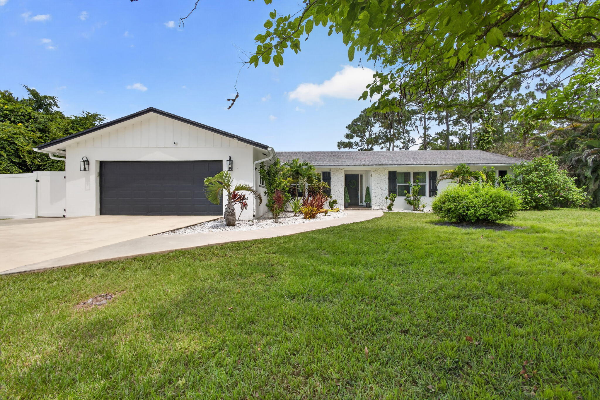 Welcome to this beautifully updated 4-bedroom, 2.5-bath home in the highly sought-after, non-HOA community of Jupiter Farms. Designed for both everyday living and effortless entertaining, this home features a spacious open-concept floor plan centered around an oversized kitchen island, complete with white quartz countertops, stainless steel appliances, a wine/beverage refrigerator, and abundant storage.  Enjoy seamless indoor-outdoor living with passthrough windows to the pool area, a bright sunroom perfect for a home office or flex space, and a large backyard ideal for gatherings. The private primary suite offers a relaxing retreat with a Jacuzzi tub and updated finishes.  Additional highlights include a large storage shed complete with electric, ample parking for vehicles, boats, or recr eational toys, and tasteful updates throughout. A separate RV septic tank at the front of the property provides added convenience for RV owners and guests. Ideally located near PGA Boulevard and Indiantown Road, with easy access to shopping, dining, top-rated schools, and just minutes from Jupiter's beautiful beaches, this property offers the perfect blend of space, style, and freedom.