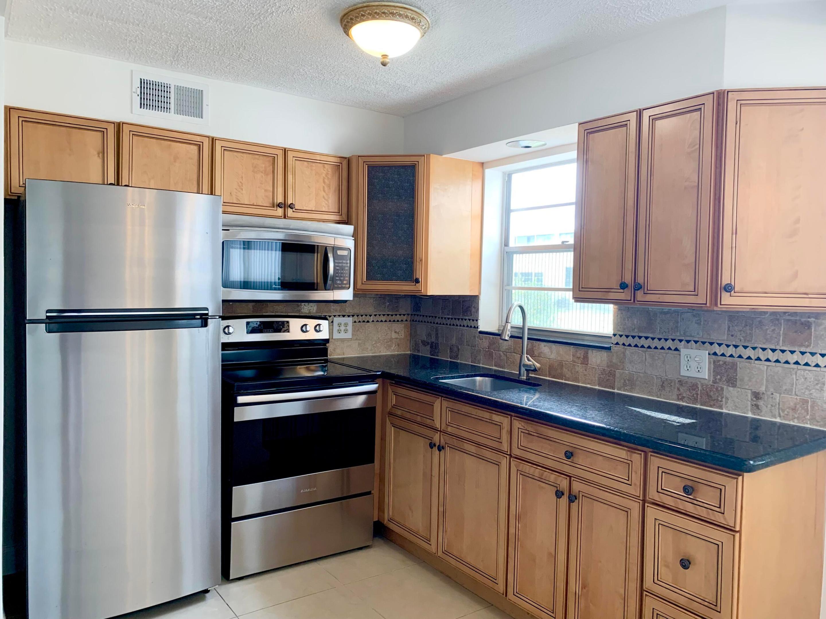 55+ RARE CORNER, FIRST FL, 2 BDRM - "2 FULL BATHS" -UPDATED Priced below market value - Given the exceptional value, I expect this listing to be filled quickly. FANTASTIC OPPORTUNITY to call this unit home in the sought after Century Village. that has a PLETHORA OF AMENITIES, NUMEROUS POOLS, TENNIS, STATE OF THE ART FITNESS CENTER - OVER THE TOP CLUBHOUSE, THEATER, BOCCE, DANCES, COURTESY BUSES, MANY SOCIAL CLUBS. CENTRALLY LOCATED TO DOWNTOWN, PBI AIRPORT, BEACHES. ENJOY PARADISE.