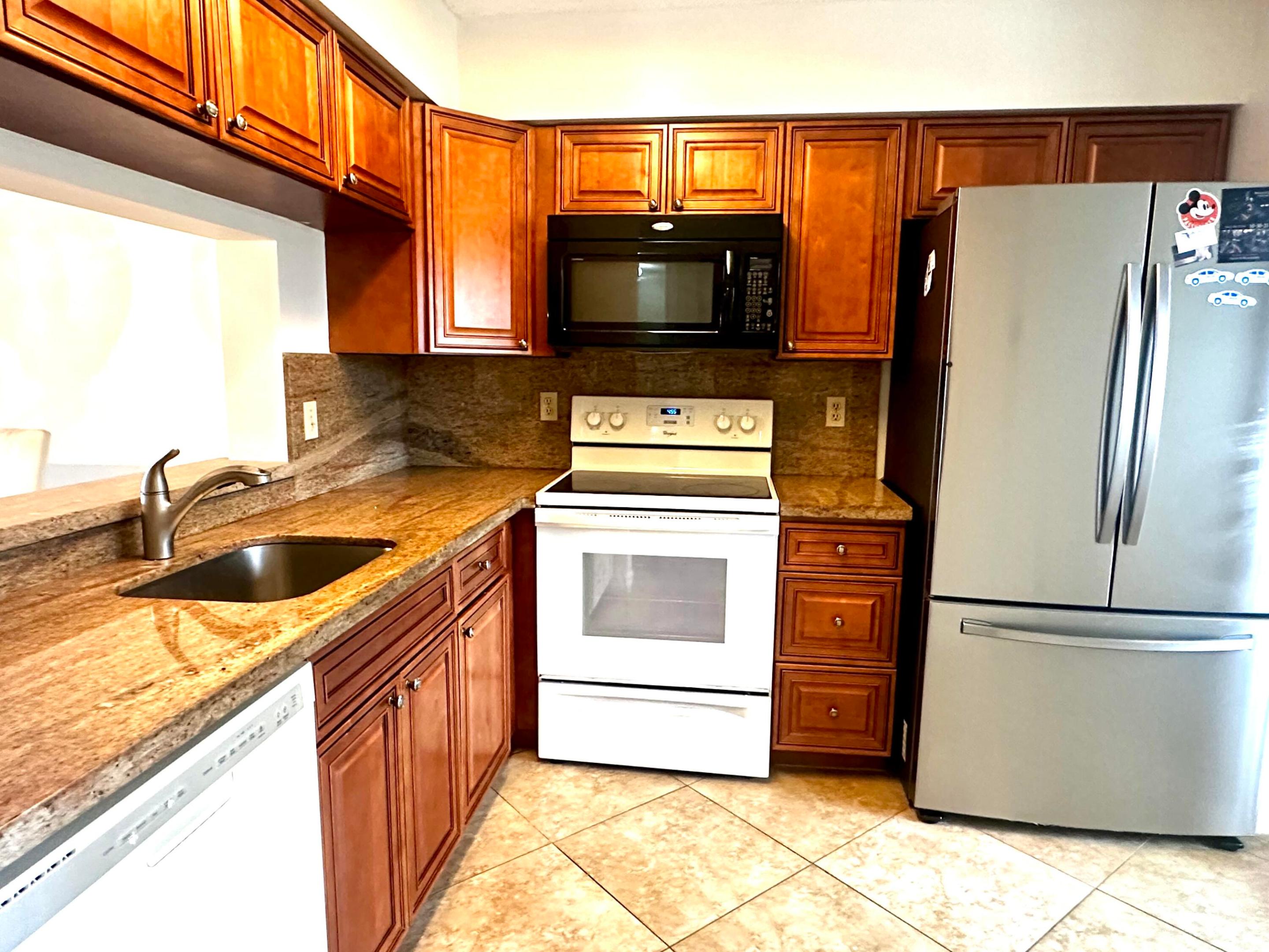 Gated community. Two bedroom 2 full bath one with a walk in tub & the primary has a shower. One of the larger units over 1200'. Bright, cheery with  an unobstructed view overlooking green space and water from your balcony. Features partial impact windows, roll down shutters,1 month NEW A/C, walking distance to clubhouse. ,Enjoy the Country club lifestyle with a clubhouse that offers top entertainment, Olympic lap size swimming pool indoor and outdoor pools, 7 pickleball courts, 4 Har Tru tennis courts, 3 paddle tennis courts, bocce, state of the art weight and exercise rooms. walking/running paths. Activities include theatre, Tues. night movies, arts, crafts, billiards, many clubs to choose from, there is so much to do & so many people to meet.  Close to famous Downtown Atlanti and beaches