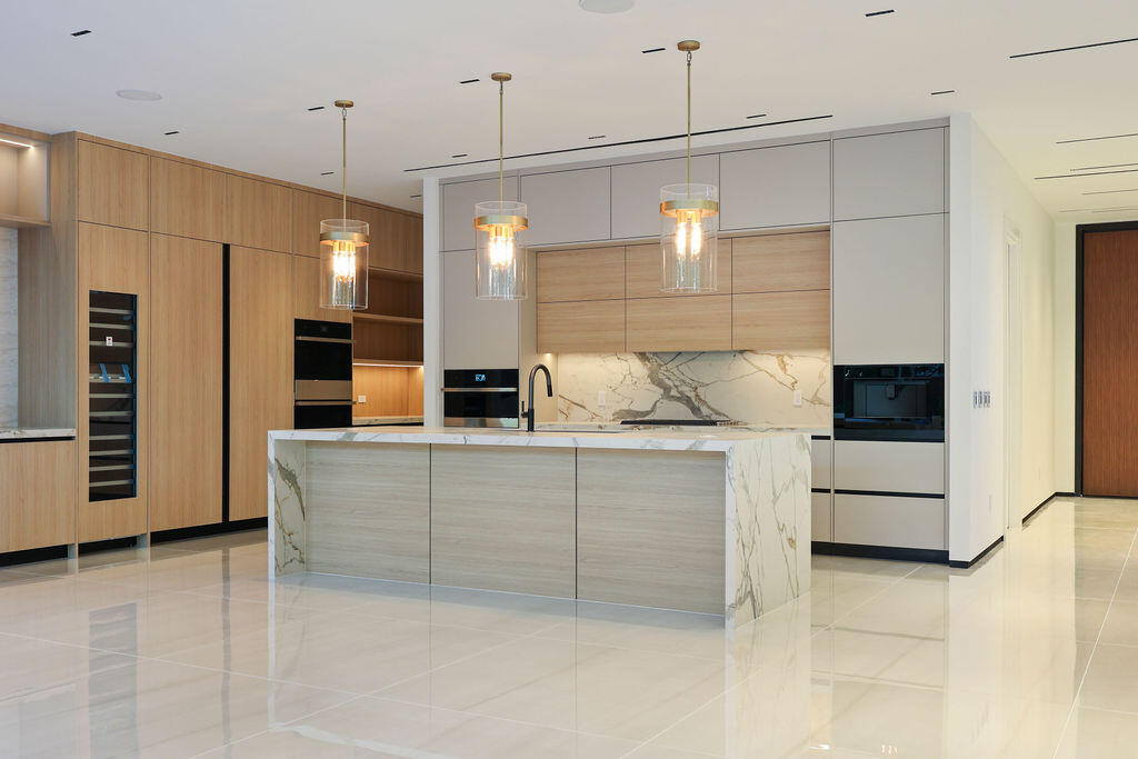 A refined take on modern luxury with fresh compositions enhanced by clean architectural lines & sophisticated aesthetics. The luminous open concept floor plan with multiple living areas showcases walls of glass that open & blend indoor & outdoor living areas with an unparalleled resort-style pool, sun shelf, spa, fire pit & summer kitchen. The chef's kitchen will inspire those who cook & entertain with an enormous center island, premium appliances including a gas cooktop, double ovens, wine, tower & custom walk-in pantry. The spacious primary suite offers 2 walk-in closets, spa inspired bathroom & balcony overlooking the tropical backyard. 3 additional ensuite bedrooms & large laundry room complete the 2nd floor.  Additional details include a 1st floor ensuite bedroom, half bathroom, floating staircase with glass railings, automated window treatments, custom accent lighting, air conditioned garage, home generator & multiple balconies. Smart technology for: lighting, air conditioning, integrated sound system, security system & more.  Square footage from appraisal.