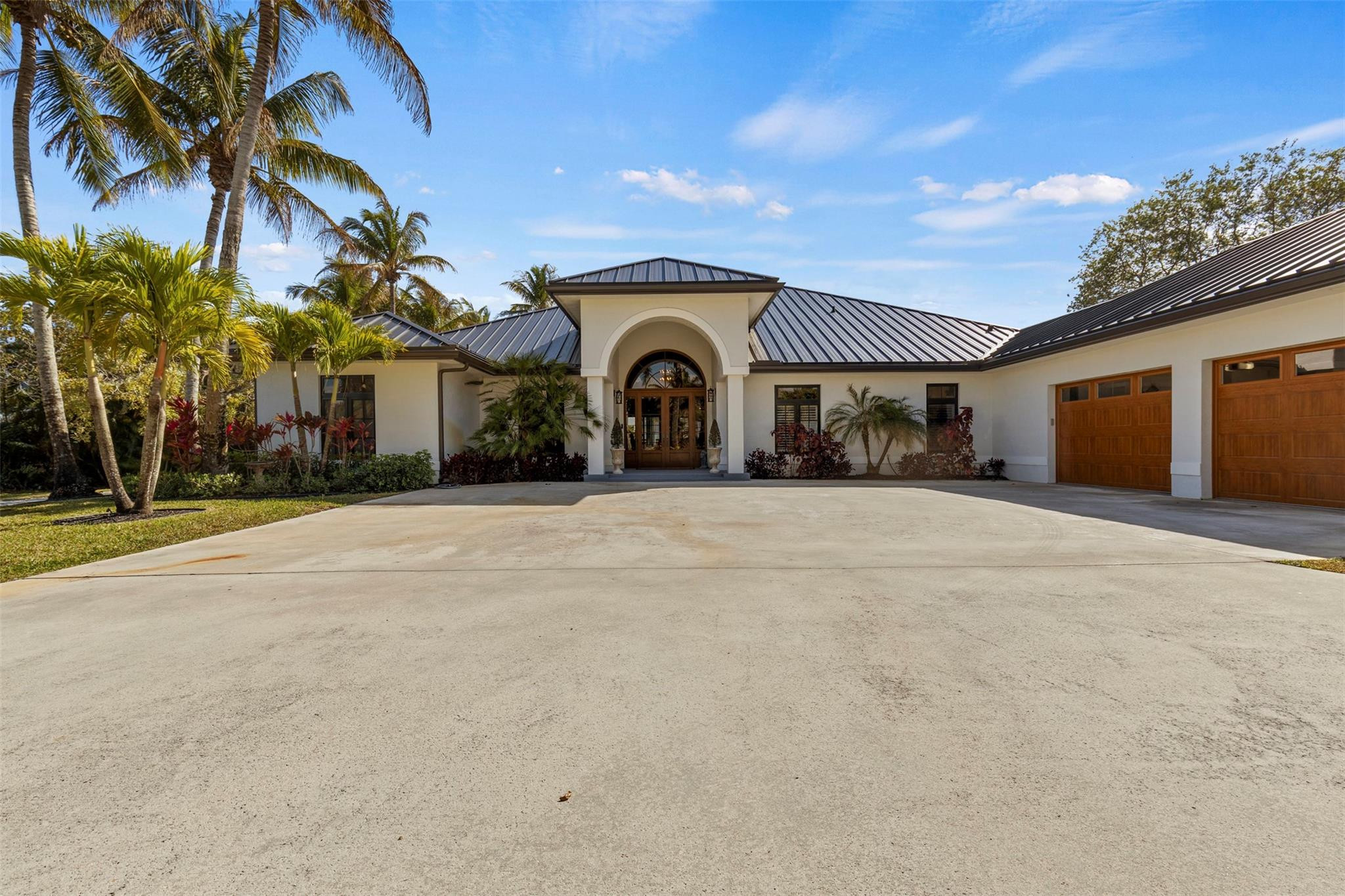 Completely rebuilt and reimagined in 2024, this exceptional Wellington estate offers luxury, flexibility, and thoughtful design at every turn. Currently operating as a charming alpaca farm, the property was intentionally designed to accommodate horses while allowing for a wide range of lifestyle uses. Whether you envision an equestrian retreat, hobby farm, seasonal income property, or a private estate close to the show, the options here are truly endless.Positioned directly on the bridle path with private gate access for hacking distance to Winter Equestrian Festival, you enjoy prime proximity without sacrificing privacy or peace of mind. 2024- Roof, Water Heaters, Electrical, Plumbing and Appliances, Barn & Workshop- 2016 A/Cs recently serviced. 500 gallon propane tank. Inside, the home is absolutely stunning. Brand-new electrical and designer lighting throughout, wide-plank wood floors, new water heaters, and a complete redesign of every bedroom, bathroom, kitchen, laundry, and living space create a true masterpiece. Designed for both elegance and functionality, the layout offers three distinct entertaining areas including a formal living room, a relaxed family living space, and a dedicated entertainment lounge with full bar setup. Every bedroom features its own en-suite bath, delivering a true luxury guest experience.The 2024 hurricane-rated barn is concrete block construction and includes the required Wellington horse hair trap system. Designed with six 12x12 stalls, each featuring individual run-outs, the barn currently functions for alpacas but was purpose-built with horses in mind. Stalls are equipped with mats and were constructed to accommodate the future installation of stall mattresses if desired. A small tack room includes a sink and refrigerator, along with a washer, dryer, and half bath for added convenience.The 1,500+ square foot warehouse is also 2024 construction with a metal roof and private entrances. Ideal for equipment storage, workshop use, feed and tack conversion, staff quarters, or additional income potential. The barn and warehouse were strategically positioned to allow ample space for an arena sized to your preference.The chef’s kitchen is beautifully appointed with a Wolf range, Sub-Zero separate refrigerator and freezer, dual dishwashers, and an elegant butler’s kitchen with its own sink and full-size Sub-Zero refrigerator and freezer combination. The entertainment lounge includes double beverage refrigerators, a dishwasher, and a full bath that doubles as a pool bath. The thoughtfully designed laundry room connects directly to a private dog run, keeping pets secure and separate from pasture areas. Every detail was carefully considered.Fully fenced and cross-fenced pastures, two separate gated entrances for home and barn access, a 500-gallon propane tank, dual zoned A/C systems under 10 years old and recently serviced, and virtually all new systems throughout provide peace of mind and storm-ready durability.Luxury. Versatility. Location. Income potential.This is Wellington living without compromise, designed for whatever chapter you choose next.