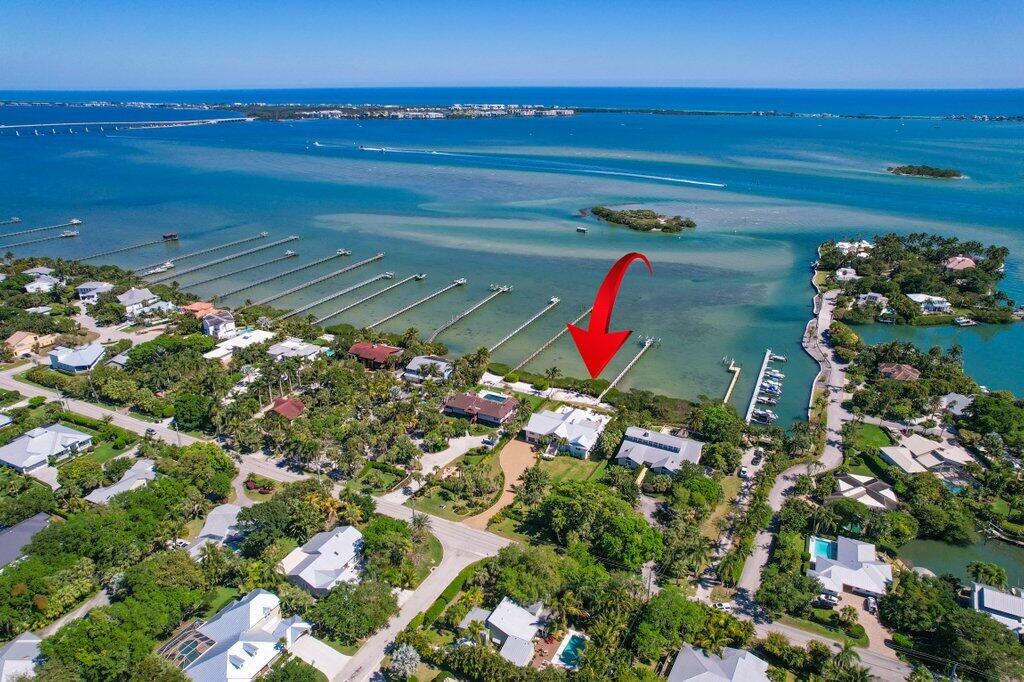 Coastal Elegance Redefined - A Waterfront Masterpiece in Sewall's Point.  Nestled along 132 feet of breathtaking turquoise blue Intracoastal waters on just under an acre, this estate is a true architectural gem, reimagined in a Hamptons-meets-California style by the renowned Kelly & Kelly Architects. Over the course of a meticulous three-year renovation, this estate has been completely transformed, offering an exquisite blend of timeless sophistication and modern luxury, all with unparalleled views of Bird Island.

Designed for effortless waterfront living, this home has been rebuilt from the ground up, featuring block construction on the lower level and HardiePlank siding on the main level. All-new impact glass doors and windows, a reinforced garage door, new electrical, plumbing, dual tankless hot water heaters, A/C units, and a whole-house generator.

Inside, every detail has been thoughtfully curated. Stunning custom woodwork graces every room, wall, and ceiling, while soaring impact windows frame panoramic water views from every space. A dramatic three-sided quartzite fireplace anchors the living area, flowing seamlessly into the chef's kitchen, where a 60" Viking range, two dishwashers, a panel-ready refrigerator, and a separate bar with wine refrigeration create an entertainer's dream.

The primary suite is a private retreat of its own, offering a tranquil sitting area and an indulgent spa-like bath, wrapped in marble, Carrara, limestone, and slate. 

The resort style patio and backyard features a built in grilling station with refrigeration and wine/beverage storage, a salt chlorinated pool with tumbled marble pool deck and four fire features enhance the ambiance, creating an atmosphere of refined relaxation.  Stunning sunrises and the beautiful views are endless. 

For the boating enthusiast, the new Trex dock is fully equipped with two boat lifts, water and electrical service, snook lighting, a ladder for easy access, and full dock illuminationready for days spent exploring the sparkling waterways. A residential elevator provides effortless access to all levels.

Basement area has 4 car garage, gym/workout area, and additional storage.  Plans are available to build an additional guest house and 5 car garage.  You will not find this anywhere on the Treasure Coast! Currently the 4th bedroom wall was removed to have another family room, but could easily be added back.  Please see plans/renderings attached. 

Set in the heart of Sewall's Point, a sanctuary for birds and native flora, this extraordinary waterfront estate is a rare offering of elegance, craftsmanship, and coastal beauty.

A home of this caliber is rarely available.  schedule your private showing today.