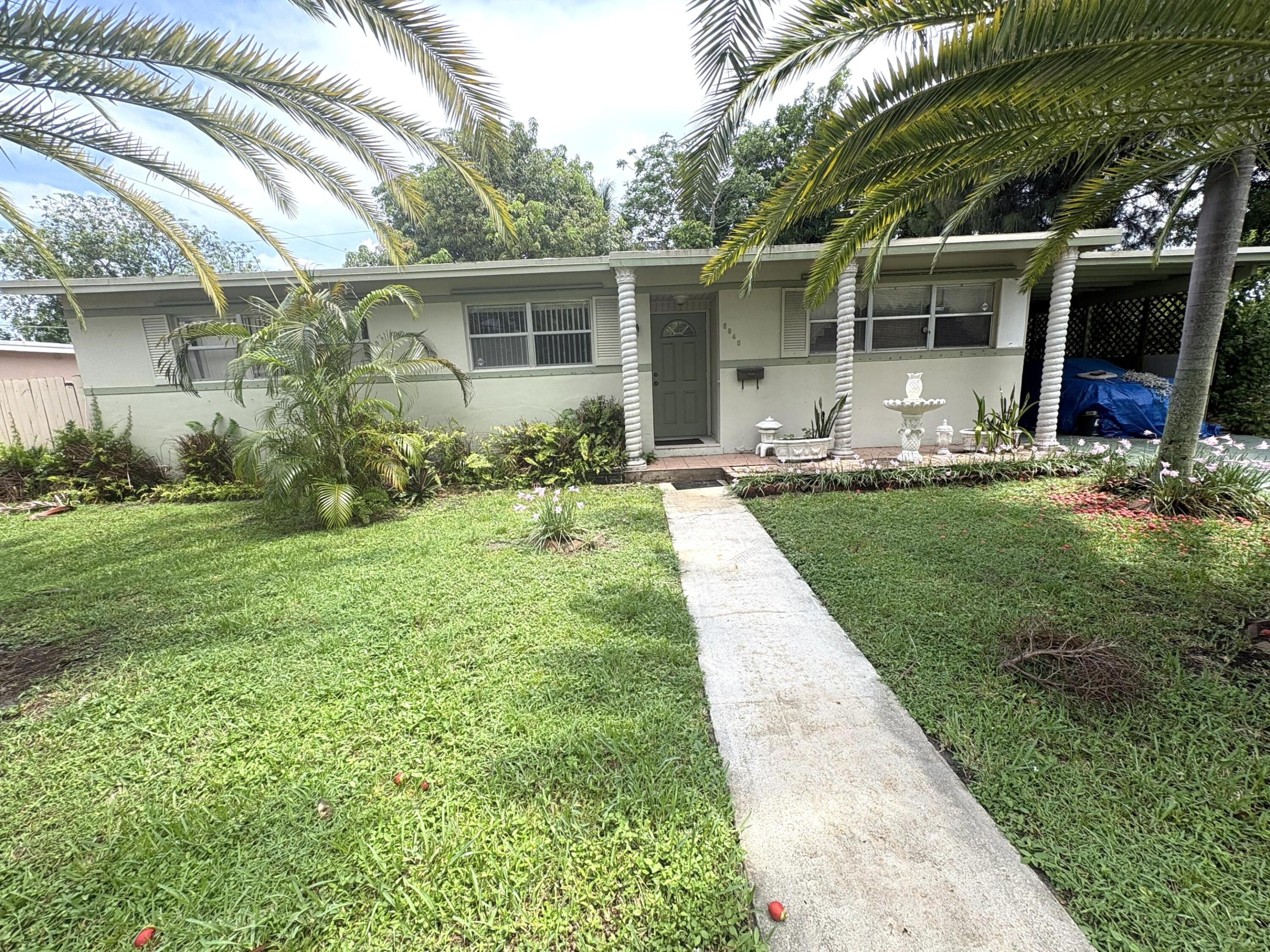 charming Plantation home situated on a desirable corner lot, offering the perfect blend of comfort, functionality, and outdoor enjoyment. This well-maintained 3-bedroom, 2-bath residence features spacious living areas with durable tile flooring throughout, creating a bright and inviting atmosphere. The updated kitchen is equipped with granite counter tops, rich wood cabinetry and stainless steel appliances, making meal preparation both stylish and convenient. A generously sized family room provides the ideal space for entertaining guests or relaxing with loved ones. Enjoy added efficiency with a tankless water heater and appreciate the convenience of a covered 1-car carport. Step outside to a private patio surrounded by mature fruit trees,  creating your own backyard retreat. With plenty of space both inside and out, this Plantation gem is ready to welcome its next owner home.