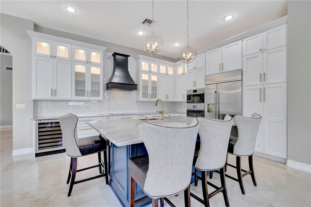 Enjoy this Gorgeous Waterfront Estate with 6 beds, 5 baths, plus office and oversized bonus space on a quiet cul-de-sac nestled in Heron Bay Oldbrooke. BRAND NEW Gourmet GE Advantium kitchen w/ stainless steel appliances, double oven, wine fridge, farm sink, and 7x4 ft island quartzite island.  Marble floors line the main living areas with grand 20 ft ceilings, built-in speakers, upgraded ceiling fans & chandeliers, and window treatments. Enjoy 2 walk-in closets and a cozy sitting area in the spacious master suite. The private fenced backyard features a heated SALTWATER Pool & Spa, lush tropical landscaping, motorized retractable patio screen, and 100+ ft of waterfront frontage. Freshly painted, accordion shutters, central vacuum, and a transferrable home warranty. Roof=2018, 3-A/Cs=2015