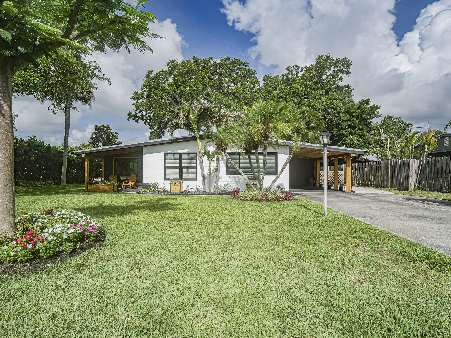 Don't miss out on this beautifully renovated Modern Mid-Century home with new appointments that include a metal roof, all hurricane impact glass throughout, updated open kitchen area with stainless steel appliances and LVP flooring. Light and bright 20x12 family room too! Corner lot with lush landscaping, fenced back yard for privacy and a storage shed.  Just five minutes to the beaches, shopping and parks.   No HOA or deed restrictions.
