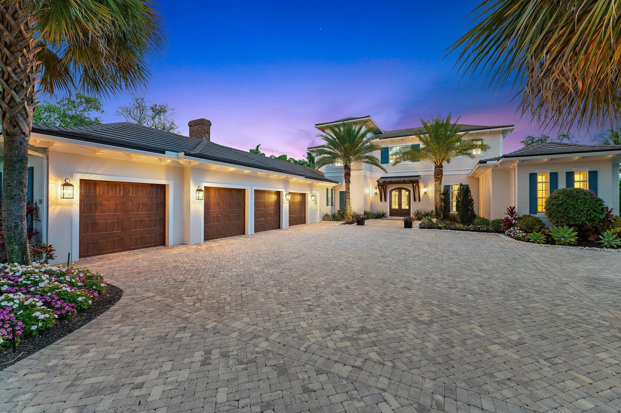 Don't miss this rare opportunity for a luxury Loxahatchee Riverfront estate for you and your family. Sitting on just under 1-acre of land with a majestic backyard Oak tree, this coastal home is move-in ready. Featuring high ceilings, the Master wing includes two oversized closets, his and her bath areas with deep soaking tub. The marble Fireplace anchors the formal living and dining rooms with coffered ceilings and French doors calling you to the waterfront patio and pool deck.  The chef's kitchen has custom cabinetry, separate walk-in pantry, wine cooler and an island breakfast bar connecting to the family room. You and your guests can enjoy the covered patio with summer kitchen and cabana bath as a perfect party location next to the heated pool w/ spa. The den/5th BR with poolside French doors, sits in the center of the house. The cabinets and shelving in the hallway near a side/delivery door, can be used as shipping and package receiving. Use the elevator to make your way up to the 2nd floor bedrooms each with en-suite baths and French doors that open to the balcony and magnificent riverfront views. Enjoy special events in the large second floor party room with beverage refrigerator and catering cabinets. The property is gated, fenced-in and tree lined with privacy in mind.  Your cars and storage will fit perfectly in a large, clean air-conditioned 4-car garage. The 16,000lb boat life and dock with LED lights make this a perfect home to entertain in, Jupiter Waterfront Style!