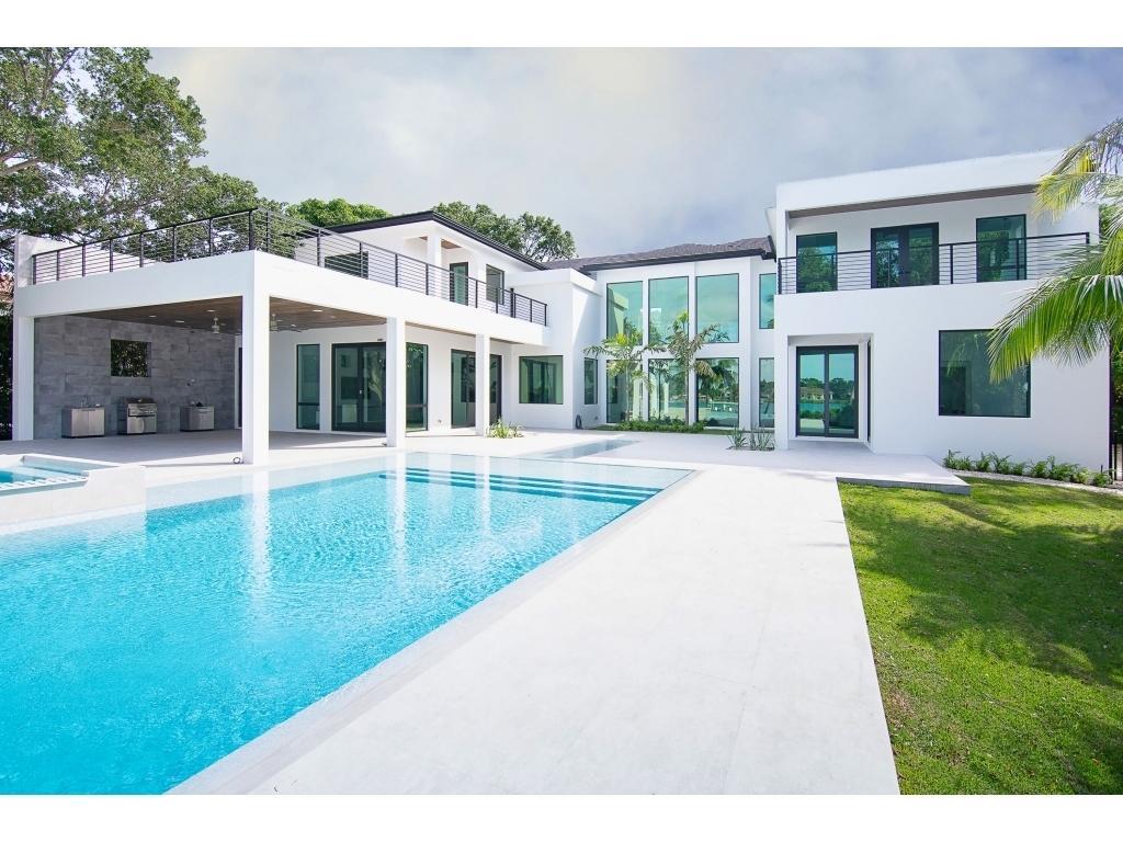 Magnificent waterfront estate home situated on 0.75 acres. Features truly unbelievable views of Loxahatchee River, spacious backyard, summer kitchen, pool resort style pool with spa, dock, and white beach. Ocean access. State of the art NEW construction and design, poured cement second floor, hurricane impact windows, open plan chefs kitchen and the best of appliances, technologies and finishes..