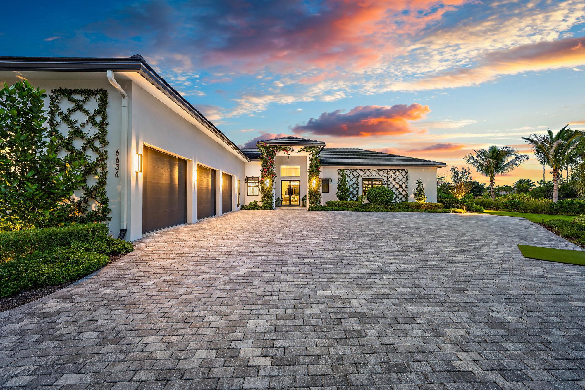 Nestled within the exclusive Ibis Golf & Country Club, this stunning custom estate offers exceptional privacy, luxury, and scale from its premier 3/4-acre cul-de-sac setting overlooking a serene natural preserve. Designed for elegant single-story living, the residence spans approximately 6,500 square feet under air and features five spacious en-suite bedrooms, six full baths, and two half baths, all arranged within a bright, open floor plan that blends grand entertaining spaces with comfortable everyday living.  Adding to its rare appeal, the adjacent .68-acre lot is also available for purchase, creating an extraordinary opportunity to expand the estate, build a guest home for extended family, or design the ultimate private family legacy compound.  Whether envisioned as a multi-generational retreat, enhanced entertaining destination, or one-of-a-kind country club estate, this offering presents a level of flexibility and future potential that is seldom found.  From the moment you enter, dramatic 16-foot volume ceilings create an impressive sense of arrival, while 12-foot ceilings throughout the home enhance the airy, expansive feel. Solid interior doors, impact windows, 12-inch baseboards, quality craftsmanship, and high-end finishes reflect thoughtful attention to detail throughout. The chef's kitchen is beautifully equipped with premium Viking appliances, an eight-burner stove, Dacor refrigerator, dual ovens, and dual dishwashers, opening seamlessly to the family room with a wet bar and ice maker for effortless entertaining.  The spacious owner's suite is a private retreat featuring a sitting area, wet bar, expansive his-and-her walk-in closets with custom built-ins, including automated racks in hers, and luxurious his-and-her baths with a distinctive dual shower. Sliding glass doors open directly to the backyard, creating a seamless connection to the resort-style outdoor living areas.  The outdoor space is a true private oasis, backing to the preserve for exceptional tranquility and natural views. A massive covered loggia with electric screens, summer kitchen with bar, shell rock pavers, cabana bath, and a spectacular 60-by-20 heated pool and spa with sun shelf set the stage for year-round relaxation and entertaining. Over $800k in landscaping featuring Sylvester palms, triple fire bowls, golf-course grass, designer plant wall by the pool, and ample green space provide a breathtaking backdrop with room for children and pets to enjoy.  Additional living spaces include an elegant living room with French doors leading to a spacious office with built-ins, and large guest suites, each with its own personal thermostat for customized comfort. Two guest suites offer a primary-suite feel that includes a generous bonus room. The home is further enhanced by high-end insulation, additional soundproofing, a well-appointed laundry room with top-of-the-line washer and dryer, exceptional storage throughout, epoxy garage flooring, and a tankless water heater. This remarkable estate combines privacy, sophistication, and resort-style living in one of the area's most sought-after country club communities.  The Club at Ibis offers a world-class private club lifestyle in one of West Palm Beach's most prestigious communities, blending elegance, recreation, wellness, and natural beauty across 2,000 beautifully maintained acres. Celebrated for its legendary reputation and exceptional amenities, Ibis is home to 54 holes of Nicklaus-designed championship golf, including three distinctive courses, a 20-acre state-of-the-art practice facility, premier golf instruction, 15 Har-Tru HydroGrid tennis courts, pickleball, resort-style aquatics, a luxurious spa, and a 16,000-square-foot fitness complex. Members enjoy an active and enriching lifestyle with fine and casual dining venues, a vibrant social calendar, cultural programs, clubs, workshops, and wellness-focused experiences through The CORE and the Ibis BodyMind Connection. Bordering the 12,000-acre Grassy Waters Nature Preserve and surrounded by pristine fairways, waterways, and abundant wildlife, Ibis offers a rare sense of tranquility while remaining just minutes from beaches, boating, shopping, dining, Palm Beach International Airport, I-95, and Florida's Turnpike.