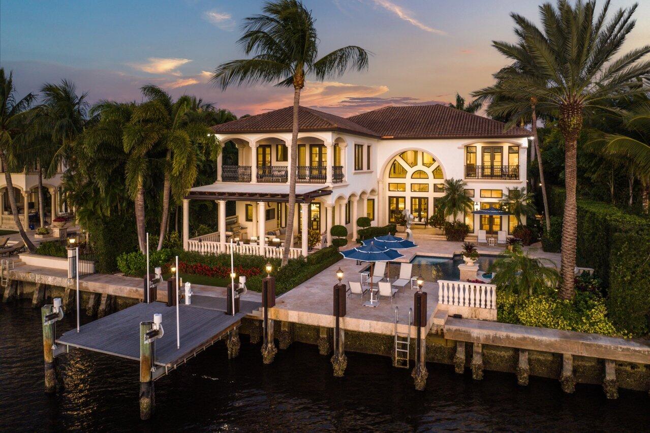 Welcome to 2348 S. Ocean Blvd. in Highland Beach. This gated estate with sweeping wide water views was masterfully built by award-winning Jeff Norman with incomparable elegance and represents the pinnacle of the South Florida lifestyle. Exuding warmth, interiors include 11,284 TSF, 5 Bedrooms, and 6.2 Bathrooms. The two-story residence is highlighted with a magical atmosphere reflecting refined finishes, subdued colors, bespoke fixtures, and stunning wood and marble work. Making an unforgettable impression, guests are greeted by an open foyer leading to the great room which features a spectacular floor-to-ceiling stone fireplace, adjacent temperature-controlled wine room and floor-to-ceiling windows and doors opening to the free-form saltwater pool and waterside loggia. The grand epicurean kitchen and waterside gathering room are designed to perfection representing an elegant oasis of luxe and comfort offering fine custom cabinetry with quartz and marble countertops, fully equipped butler's pantry, top shelf appliances, dual dishwashers, and six-burner Wolf gas range. Also on the first floor are an intimate library/office revealing custom mahogany built-ins, a formal dining room, and a secluded VIP guest suite with unparalleled views of the Intracoastal waters.  A private elevator and a grand staircase with a custom-designed clear stained glass window lead to the second level and upper gallery.  The owner's suite enjoys pride of place and delivers unparalleled luxury from dual his/her baths and wardrobes, morning bar, and a private balcony yielding/endless water and sunset vistas/with a seductive pull to unwind and surround yourself with nature. Three additional guest suites, one with private stair access, provide ample space for family and guests. With a hint of excitement venture outside to the tropically landscaped salt-water pool and spa, large covered loggia, with automatic phantom screens, summer kitchen with DCS grill, outdoor shower, dock with 24,000lb electric watercraft lift, all conjuring a mood for perfect entertaining. Additional features include travertine marble and wood floors, UV filtered high-impact windows and doors. two tankless water heaters, elevator, full house generator, water filter and softener system, central vacuum, poured contract 2nd floor, 5 A/C zones, smart home, 4 car garage and Sonos music system. Superbly located, the residence offers deeded beach access to the beautiful Atlantic Ocean and is moments away from a wealth of luxuries and conveniences found along Atlantic Avenue, Delray Beach. Finely curated furnishings provide an exciting move-in opportunity!!!