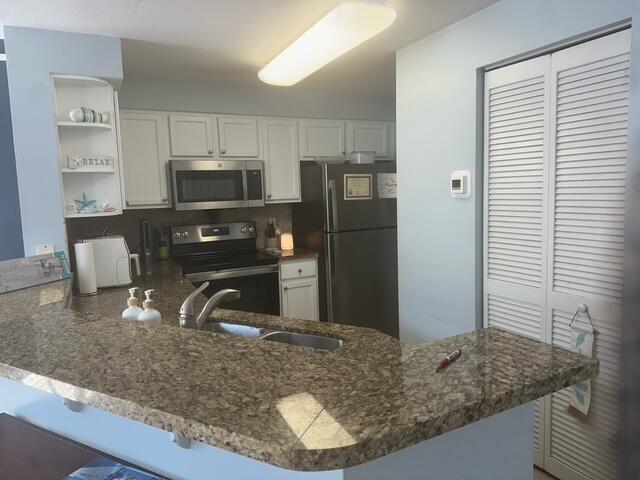3 Level condominium with great Eastern exposure.  A short walk to "A-Rated" Jupiter Schools.  2 Beds, 2.5 Baths with a 1 Car Garage.  GE Stainless Steel Appliances new in 2022 and New Roof installed in 2023.  Both Bedrooms have their own private Full Baths.  Primary bedroom has large walk-in closet.  Utility Closet has full size Washer/Dryer. Panel shutters. Somerset offers large resort-style Pool, BBQs, a Picnic Area and Playground with greenspace.  Clubhouse has Fitness Center.  All this within walking distance to Roger Dean Stadium and downtown Abacoa.  The perfect Condo in a perfect location!