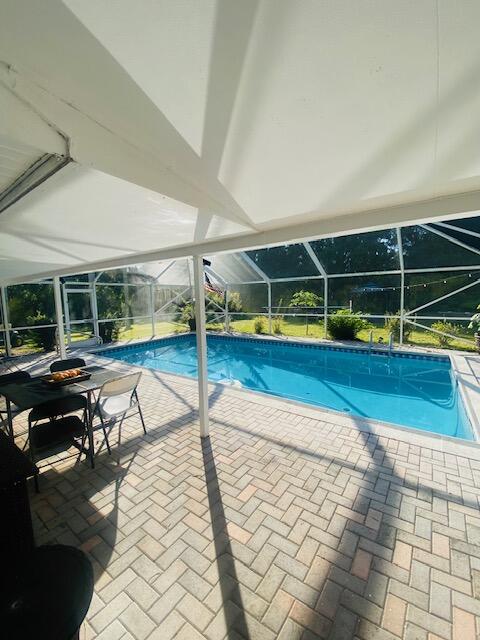 Beautiful, Spacious Pool Estate Home on 1 Acre in the Prestigious Evergreen / Crane Watch Community - Palm City, FL  This stunning estate home offers a spacious open layout with 4 bedrooms, large Florida room and a fireplace showcasing peaceful views of natural greenery. The expansive pool area features a bar and a screened-in patio, perfect for entertaining or enjoying the Florida lifestyle all year long. Recently remodeled throughout, the home includes waterproof flooring, modern baseboards, updated light fixtures.  Located in the highly desirable Evergreen (Crane Watch) Golf Course community. Residents enjoy a quiet, upscale neighborhood with an on-site restaurant/bar, Lowest priced home in area on 1 acre, with pool and in gold community. Wont last make an offer today