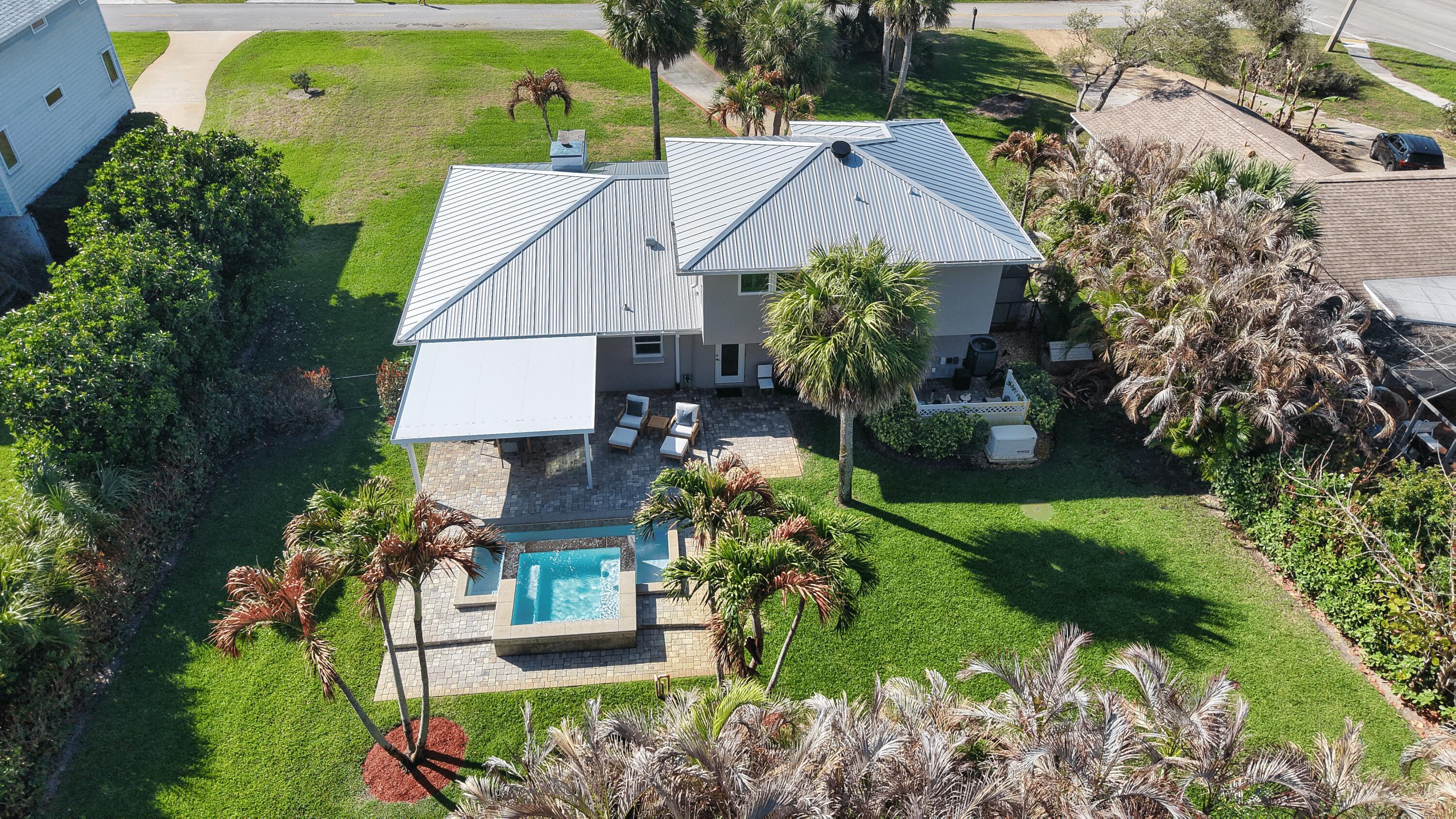 Just steps from the ocean, this Central Beach home is ideally located east of A1A & only a block from the beach in Vero Beach. This two story 3 bedroom, 2 bath property sits on a rare 0.36 acre lot with a fenced yard, spa, and paver patio for outdoor living. Interior features include plantation shutters, a kitchen with an island and breakfast bar, a Florida room, and two laundry rooms including an additional upstairs laundry. Additional highlights include a 1 car garage, security system, buried propane tank, 2021 metal roof, generator, & no HOA near Ocean Drive, beaches, shopping, and dining.