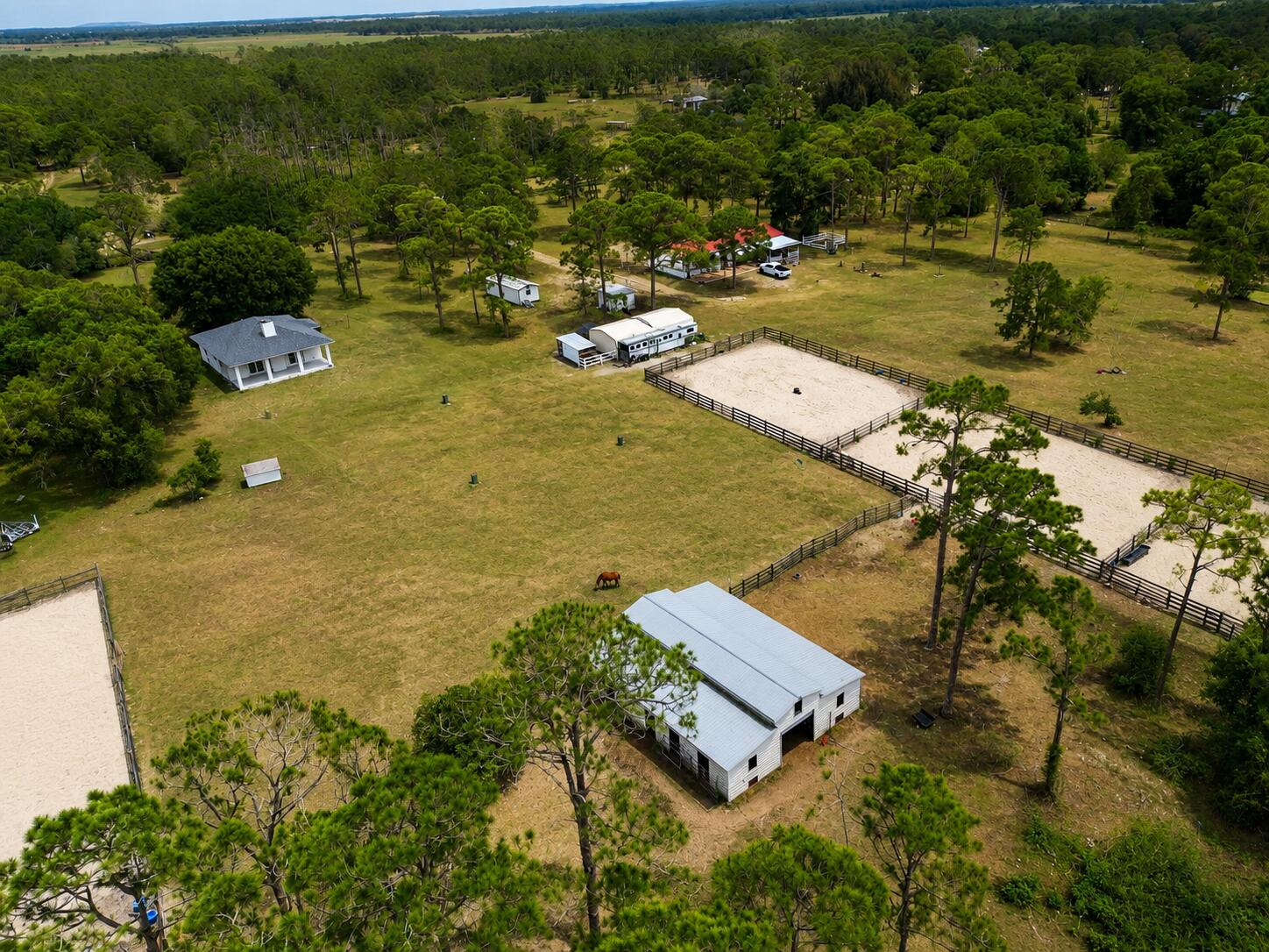 Country living meets equestrian excellence on approximately 9.46± acres in desirable Country Hills Estates. This unique property features a beautifully updated 2BR/2BA CBS home with hurricane impact windows, open-concept living, designer bathrooms, and a covered front porch overlooking the ranch. Equestrian amenities include an impressive 8-stall center aisle barn rated up to 210 MPH winds per manufacturer, 3 paddocks, and ample tack/storage space. A separate 4BR/2BA manufactured home offers excellent flexibility for guests, extended family, ranch help, or rental income. Fully fenced and gated with mature oaks and pines, this property is ideal for horse enthusiasts, hobby farmers, or those seeking a private family compound. *** Two parcels must be sold together**** ******Buyer Disclosure: Property consists of two separate legal parcels being sold together. Seller has submitted an application to combine the parcels; however, buyer may elect to maintain them separately or pursue parcel combination after closing.