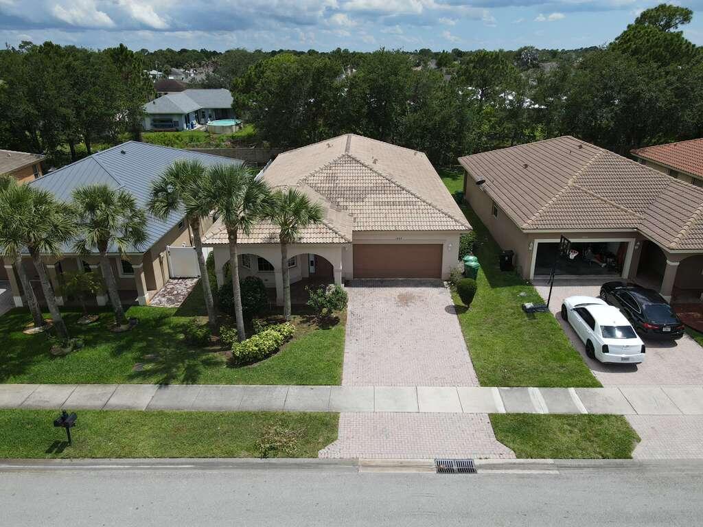 Beautiful 4/2/2 house with a private backyard and no neighbors behind the house. The house has flooring throughout the area and a remodeled master bathroom. The house has a floor plan with a living room, dining room, kitchen, and family room. Additionally, it is located in the Gatlin area, just 5 minutes from I-95, Tradition, and 2 minutes from Walmart. It is 30 minutes from Jupiter Beach. Additionally, it has a very complete clubhouse with a swimming pool, tennis courts, gym, basketball courts, pickleball, playground, sidewalk, and much more. The seller needs to sign FIRPTA addendum. Subject to errors, omissions, or changes without notice. Buyer to verify all information to their satisfaction. The seller has never lived in the houses. Seller disclosure will not be provided. The